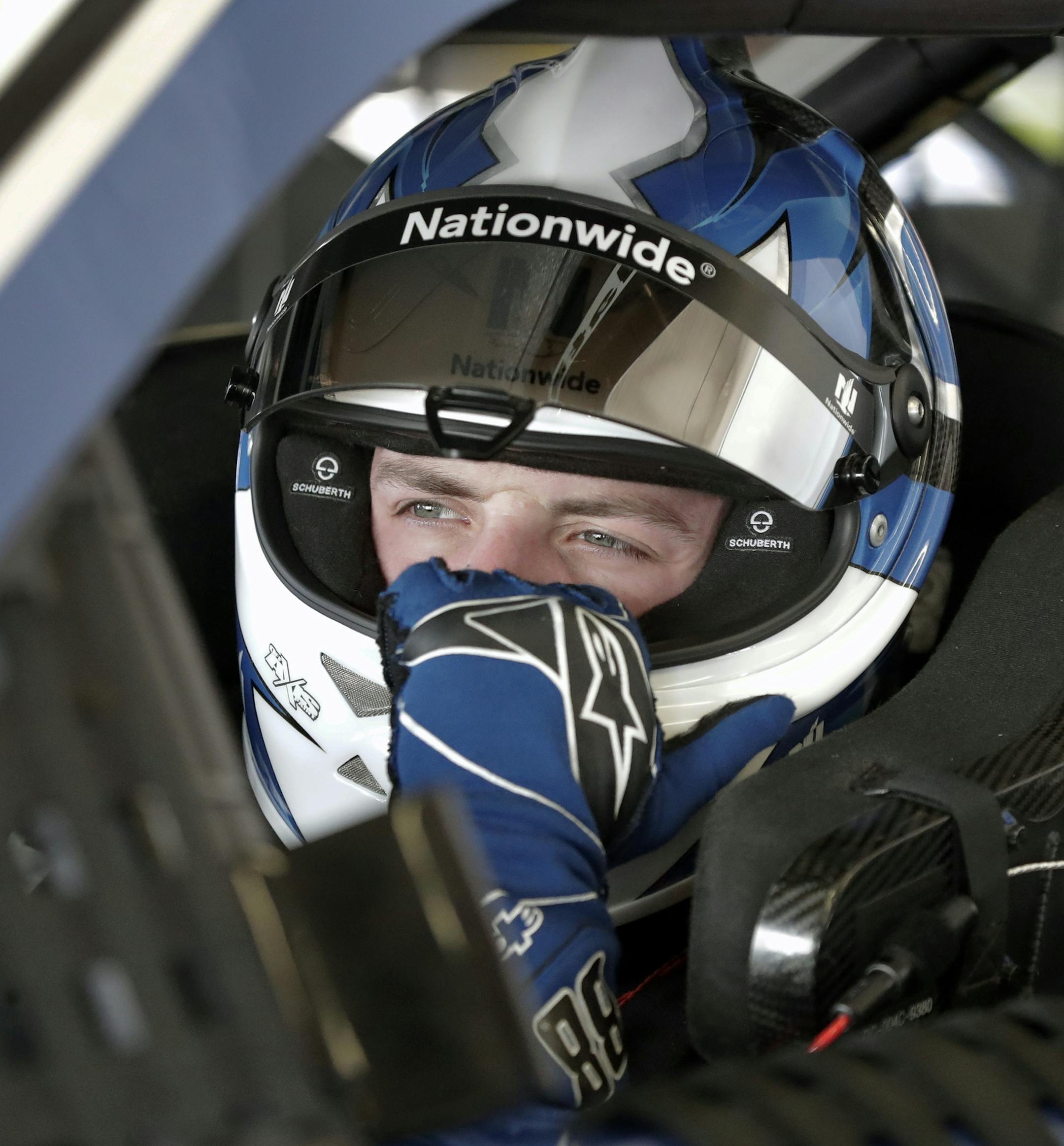 Alex Bowman adjusts his helmet before going out on the track for a practice session for the NASCAR Daytona 500 auto race at Daytona International Speedway, Friday, Feb. 16, 2018, in Daytona Beach, Fla. (AP Photo/John Raoux)