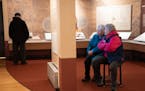 Visitors watch an oral history video in the "Many Voices, Many Stories, One Place" exhibit on Thursday at Historic Fort Snelling in St. Paul. The exhi