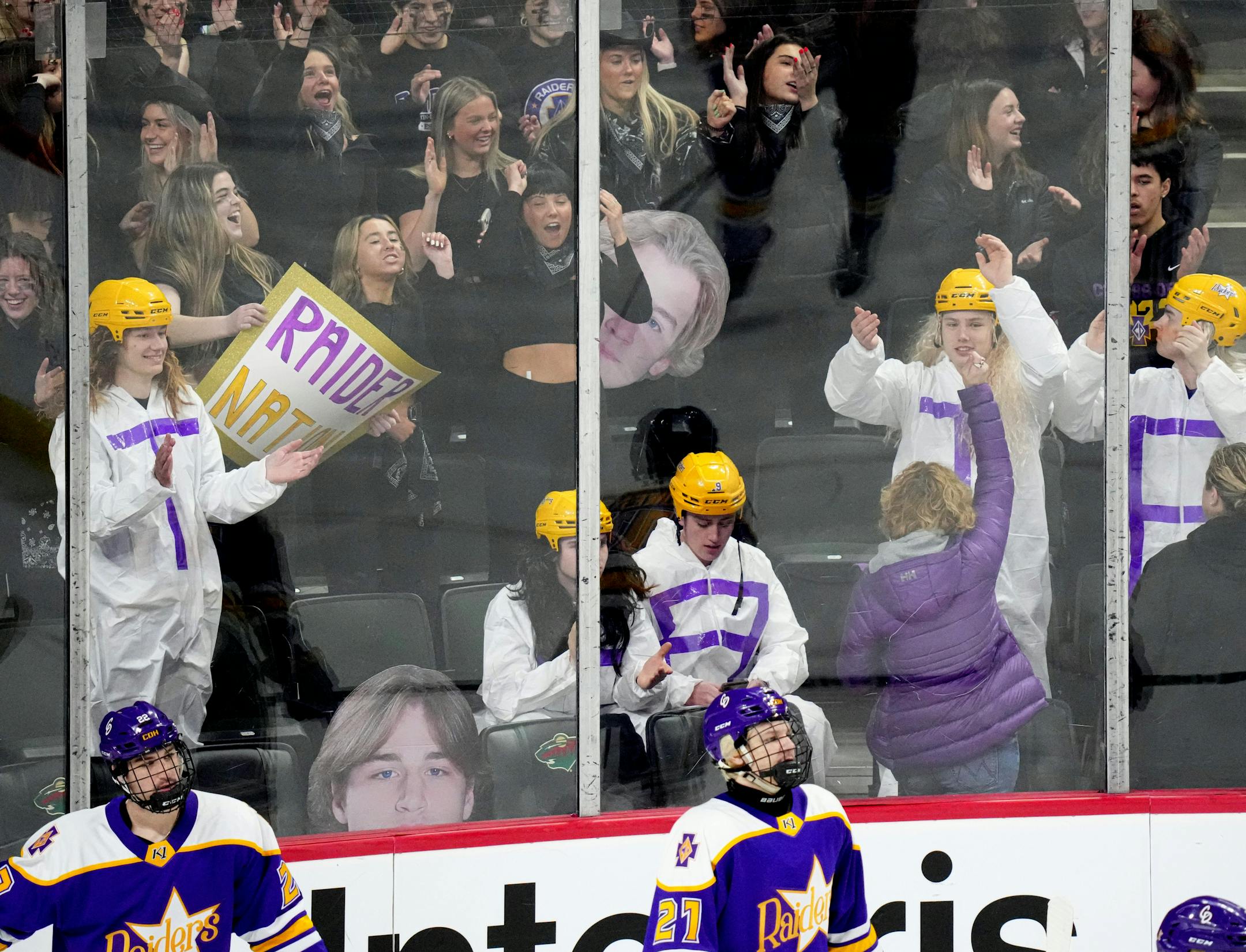 Cretin-Derham Hall fans cheered as their team took to the ice before the start of a MSHSL Class 2A quarterfinal hockey game between state tournament Cretin-Derham Hall and Maple Grove.