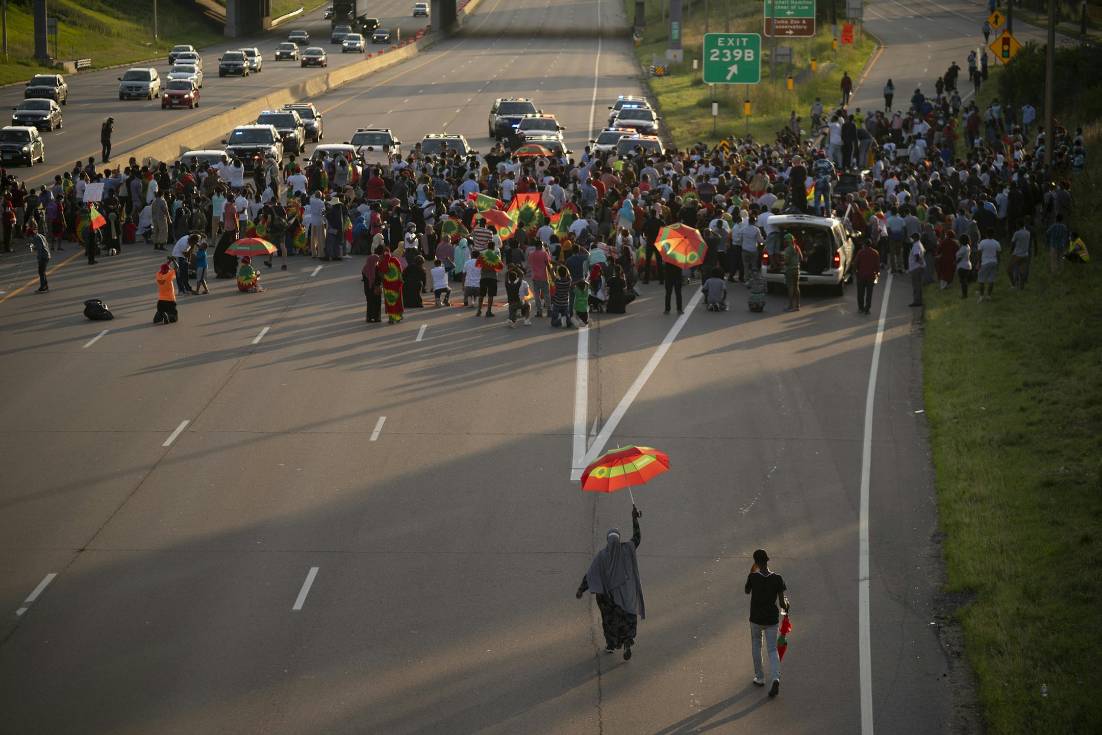 A pair of demonstrators walked to join others paused before making their way to the Lexington Ave. exit off westbound I-94. ] JEFF WHEELER • Jeff.Wheeler@startribune.com Demonstrators protesting the political situation in Ethiopia in the wake of the shooting death of musician Hachalu Hundessa, well known for his political songs, shut down westbound I-94 in St. Paul Wednesday evening, July 1, 2020 before exiting at Lexington Ave. and continuing to protest peacefully.