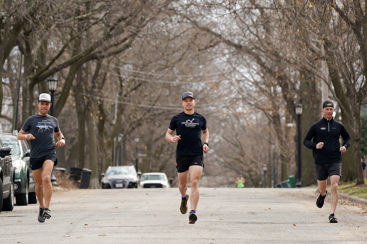 Runners, from left, Aaron Boike, Matt Van Donsel, and Mark Johnson demonstrated how they've been running together while following social distancing guidelines.