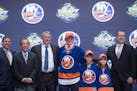 Kieffer Bellows, center, stands with members of the New York Islanders management team and others at the NHL draft in Buffalo, N.Y., Friday June 24, 2