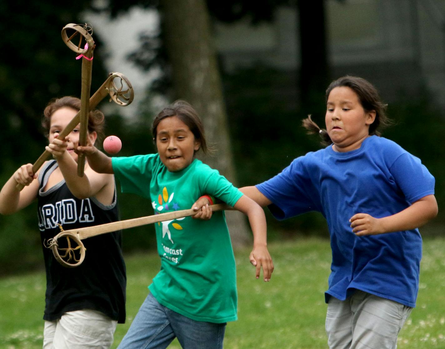 Youth members of Twin Cities Native Lacrosse practice at Corcoran Park Wednesday, June 17, 2015, in Minneapolis, MN. The traditional Lacrosse players, who play with hand carved ash sticks, were preparing for the upcoming Twin Cities Native Lacrosse Tournament at the Osseo High School Saturday. Here, Mato Ska Thompson, left to right, Santino DeCory and Julian Wells-Gonzalez compete for the ball during a scrimmage.](DAVID JOLES/STARTRIBUNE)djoles@startribune.com Though the sport of lacrosse was or