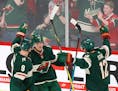 Minnesota Wild's Mikael Granlund (64) celebrated his third goal of the game with Wild teammates Mikko Koivu (9) and Eric Staal (12) against the Nashvi