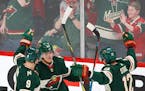 Minnesota Wild's Mikael Granlund (64) celebrated his third goal of the game with Wild teammates Mikko Koivu (9) and Eric Staal (12) against the Nashvi