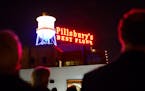 People cheered and applauded from the rooftop terrace of the A Mill Artist Lofts as the Pillsbury sign was relit Monday, Nov. 2, 2015, in Minneapolis.