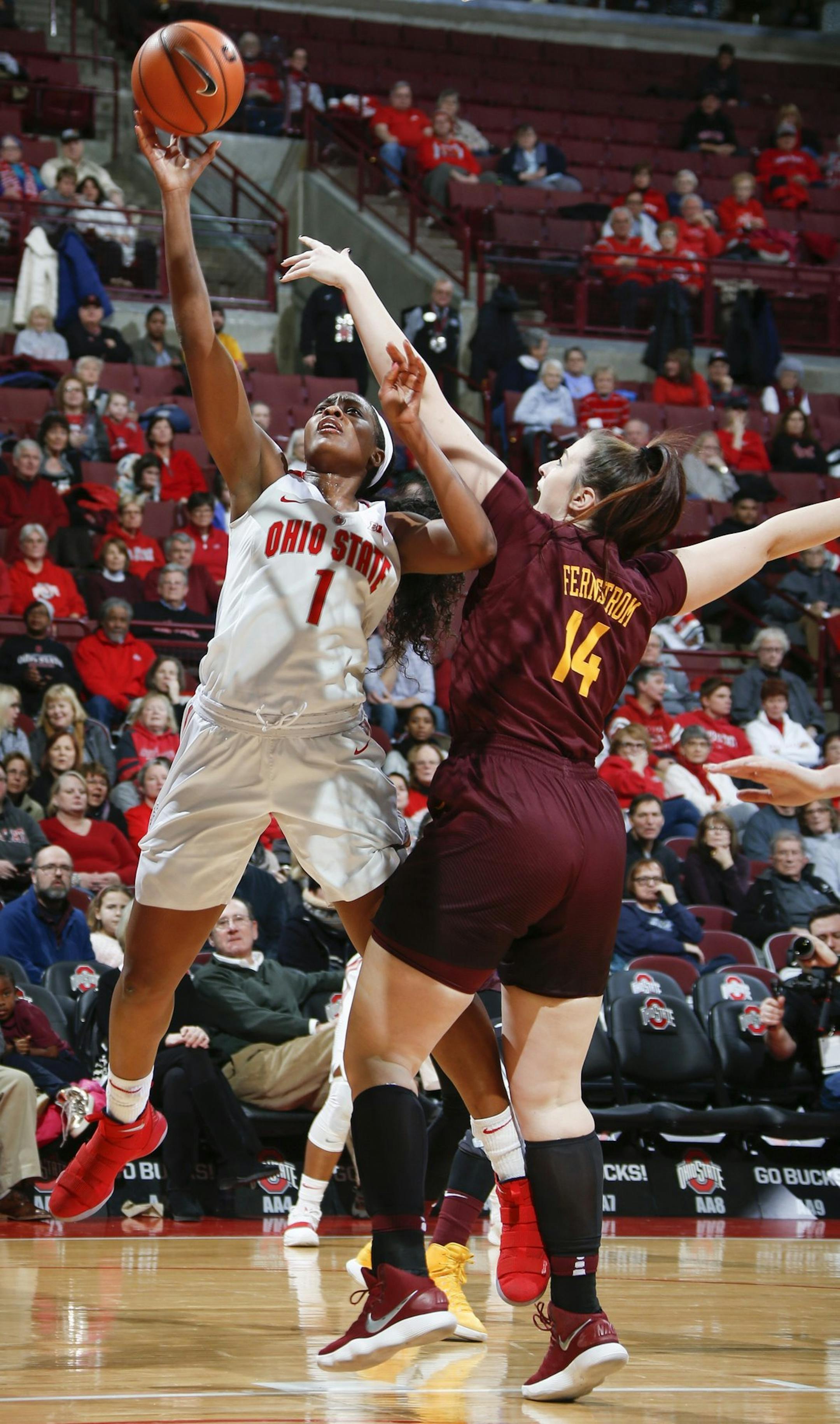 Ohio State forward Stephanie Mavunga (1) shoots a layup as Minnesota center Bryanna Fernstrom (14) fouls her during the first half of an NCAA college basketball game in Columbus, Ohio, Thursday, Jan. 4, 2018. (Joshua A. Bickel/The Columbus Dispatch via AP)