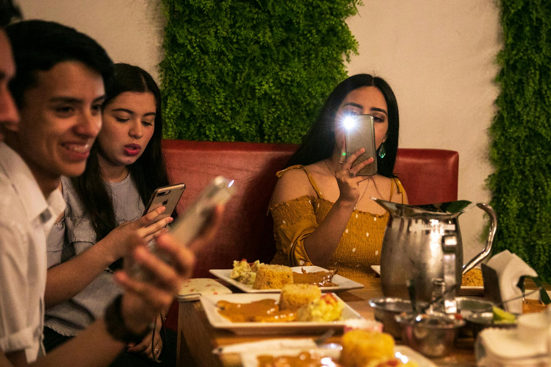 Friends of Jocelyn Guzman at a restaurant for Guzman's 18th birthday party in Matamoros, Mexico, on March 1, 2019. "Like my mom said, my dad, always, he fights for what he wants. And I’ve learned that from him. My goal is to finish school, go to college, finish college, and I want to work and I want to get paid money, so I can help them move over there with me. I want to pay them back," said Guzman. (Ilana Panich-Linsman/The New York Times)