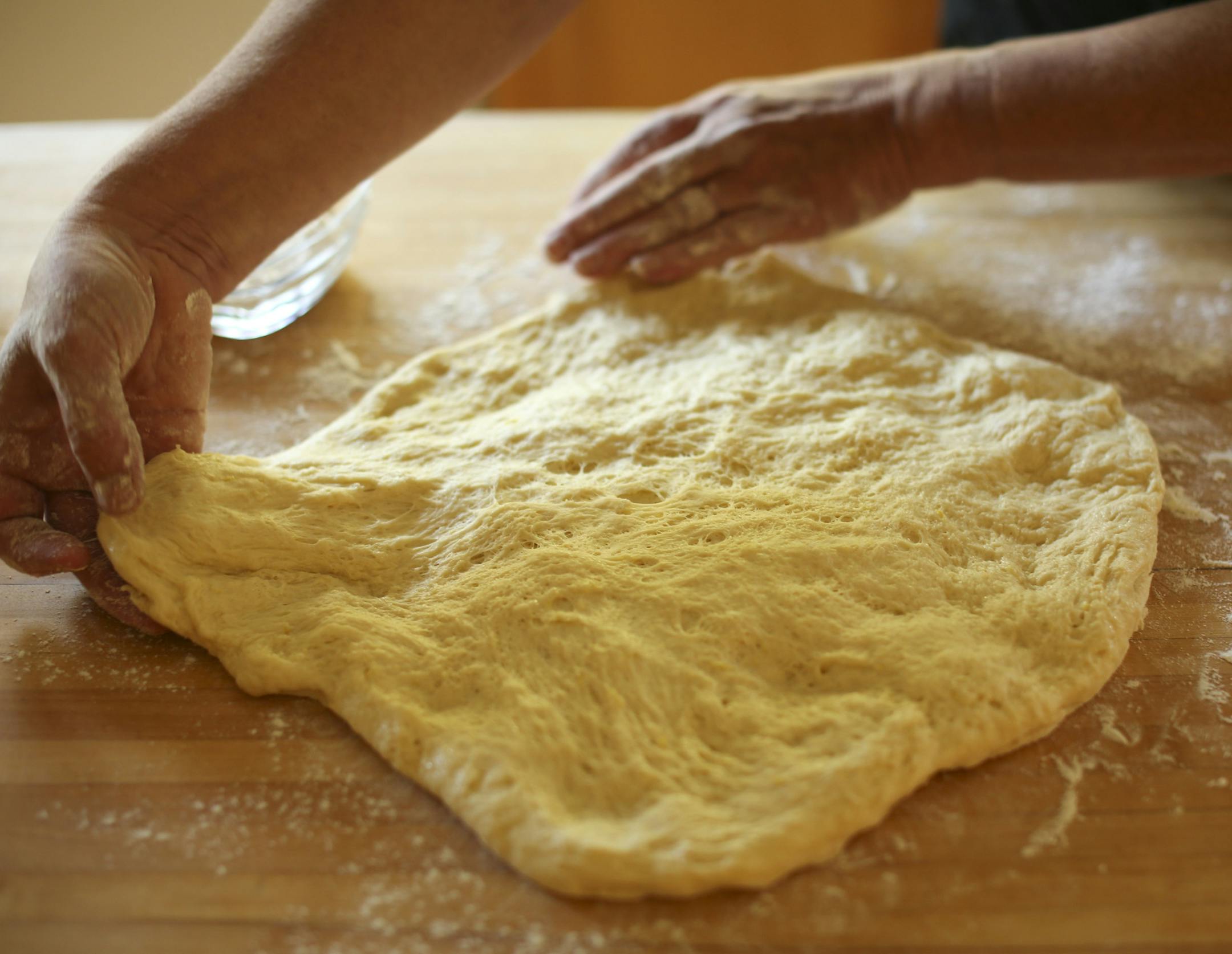 Baking Central takes on krofi, the light and lemony fried pastry from Slovenia. Krofi preparation in Kim Ode's Edina kitchen on Thursday afternoon, October 10, 2013. Pulling and stretching the dough. ] JEFF WHEELER ‚Ä¢ jeff.wheeler@startribune.com