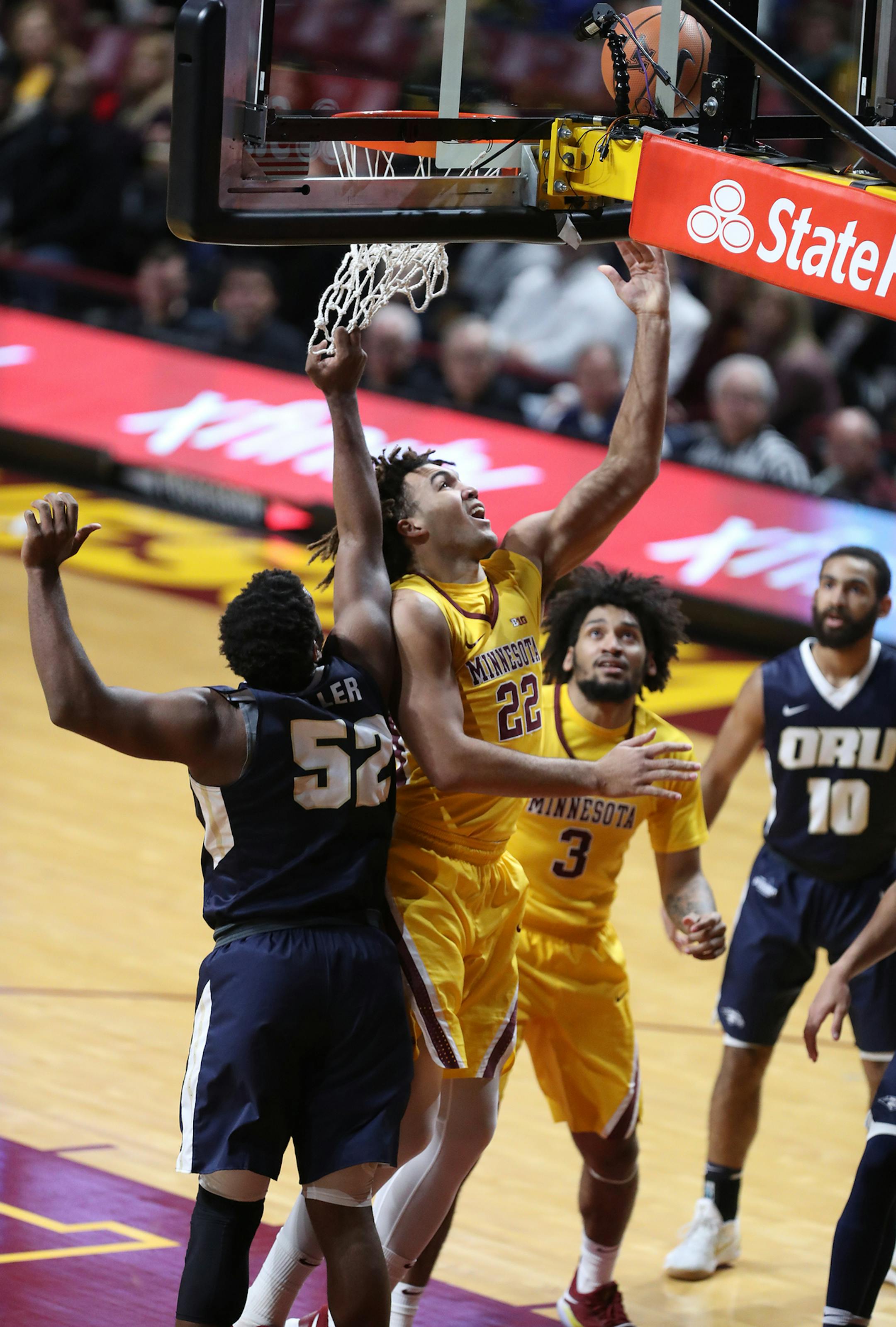 Reggie Lynch (22) of the Minnesota Golden Gophers shoots as Chris Miller (52) of the Oral Roberts Golden Eagles defends during the first half. ] LEILA NAVIDI ï leila.navidi@startribune.com BACKGROUND INFORMATION: Minnesota Golden Gophers play against the Oral Roberts Golden Eagles at Williams Arena in Minneapolis on Thursday, December 21, 2017.