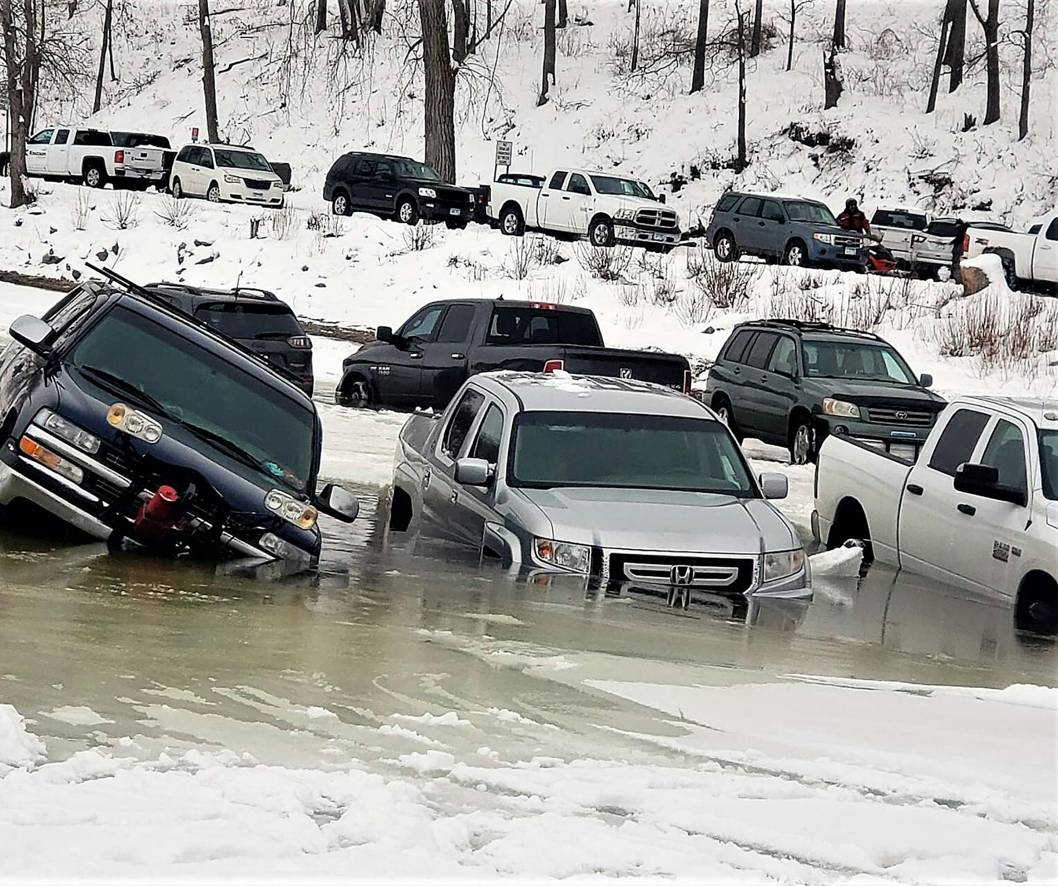 Some of about 15 vehicles parked on the Mississippi River by anglers near Frontenac, Minn., sunk Saturday morning Jan. 21. Some could be driven off, while others had to be towed.