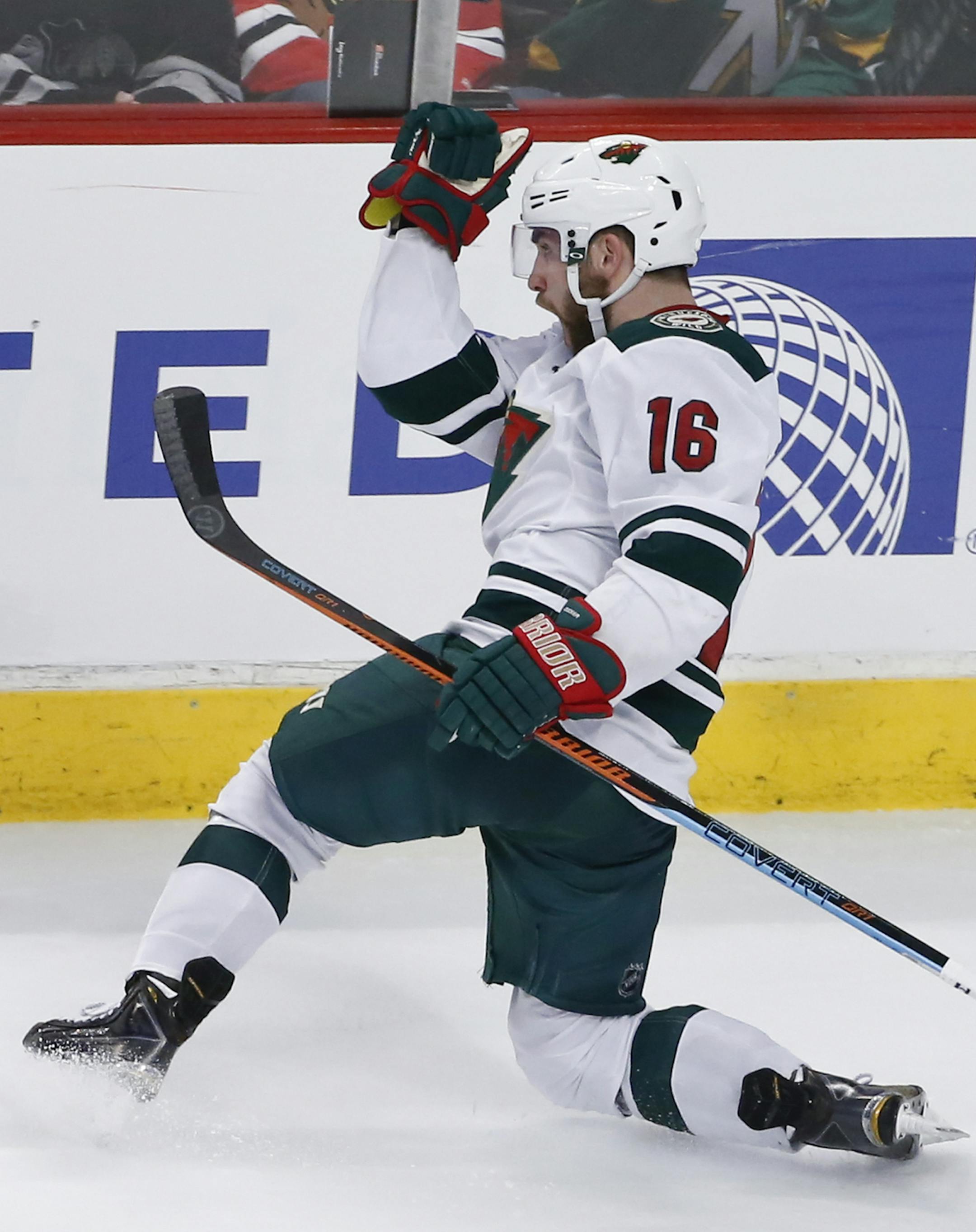 Minnesota Wild left wing Jason Zucker (16) celebrates a goal against the Chicago Blackhawks during the third period of an NHL hockey game Tuesday, April 7, 2015, in Chicago. (AP Photo/Kamil Krzaczynski) ORG XMIT: CXA111