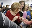 Republican presidential candidate, businesswoman Carly Fiorina greets a young child as she arrives for the 2016 Mackinac Republican Leadership Confere
