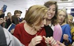Republican presidential candidate, businesswoman Carly Fiorina greets a young child as she arrives for the 2016 Mackinac Republican Leadership Confere