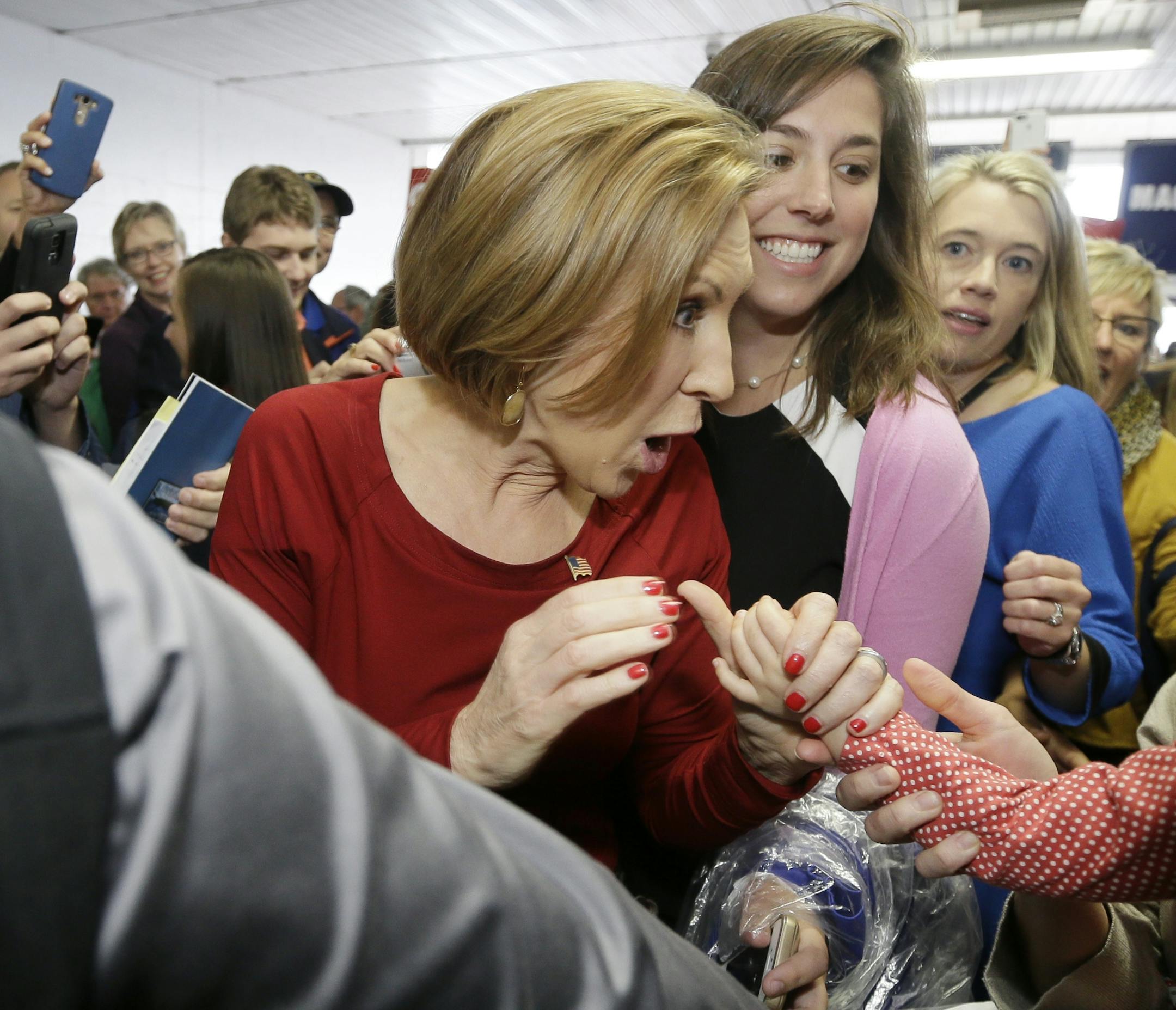 Republican presidential candidate, businesswoman Carly Fiorina greets a young child as she arrives for the 2016 Mackinac Republican Leadership Conference, Saturday, Sept. 19, 2015, in Mackinac Island, Mich. (AP Photo/Carlos Osorio)