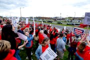 Demonstrators stood along Kenwood Trail during a rally before a school board meeting at the Lakeville District Office on Tuesday in Lakeville.
