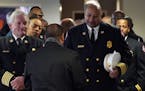 Minneapolis Fire Chief John Fruetel and Assistant Chief Bryan Tyner lined up before processing in to Ron Edwards funeral service Saturday.