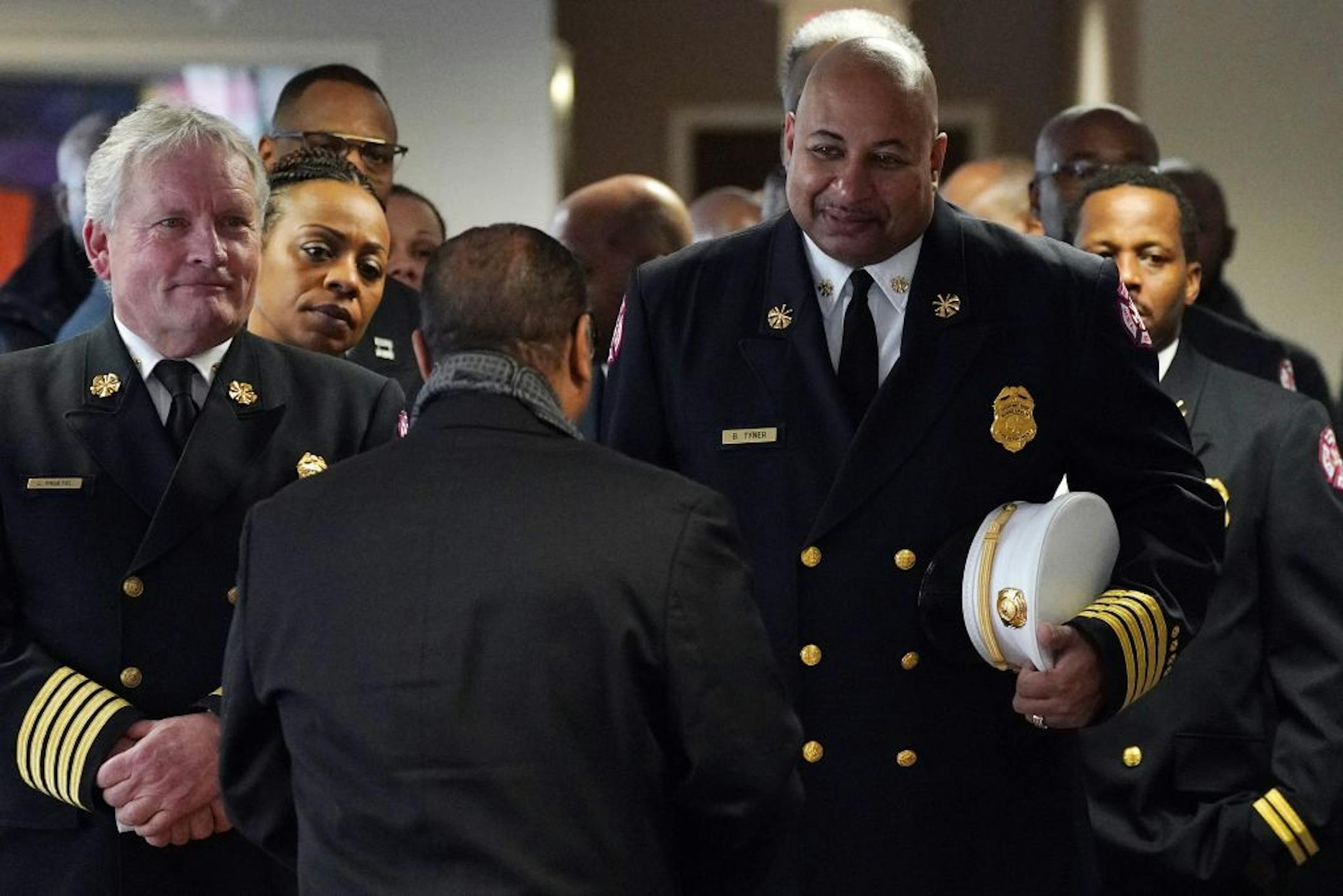 Minneapolis Fire Chief John Fruetel and Assistant Chief Bryan Tyner lined up before processing in to Ron Edwards funeral service Saturday.