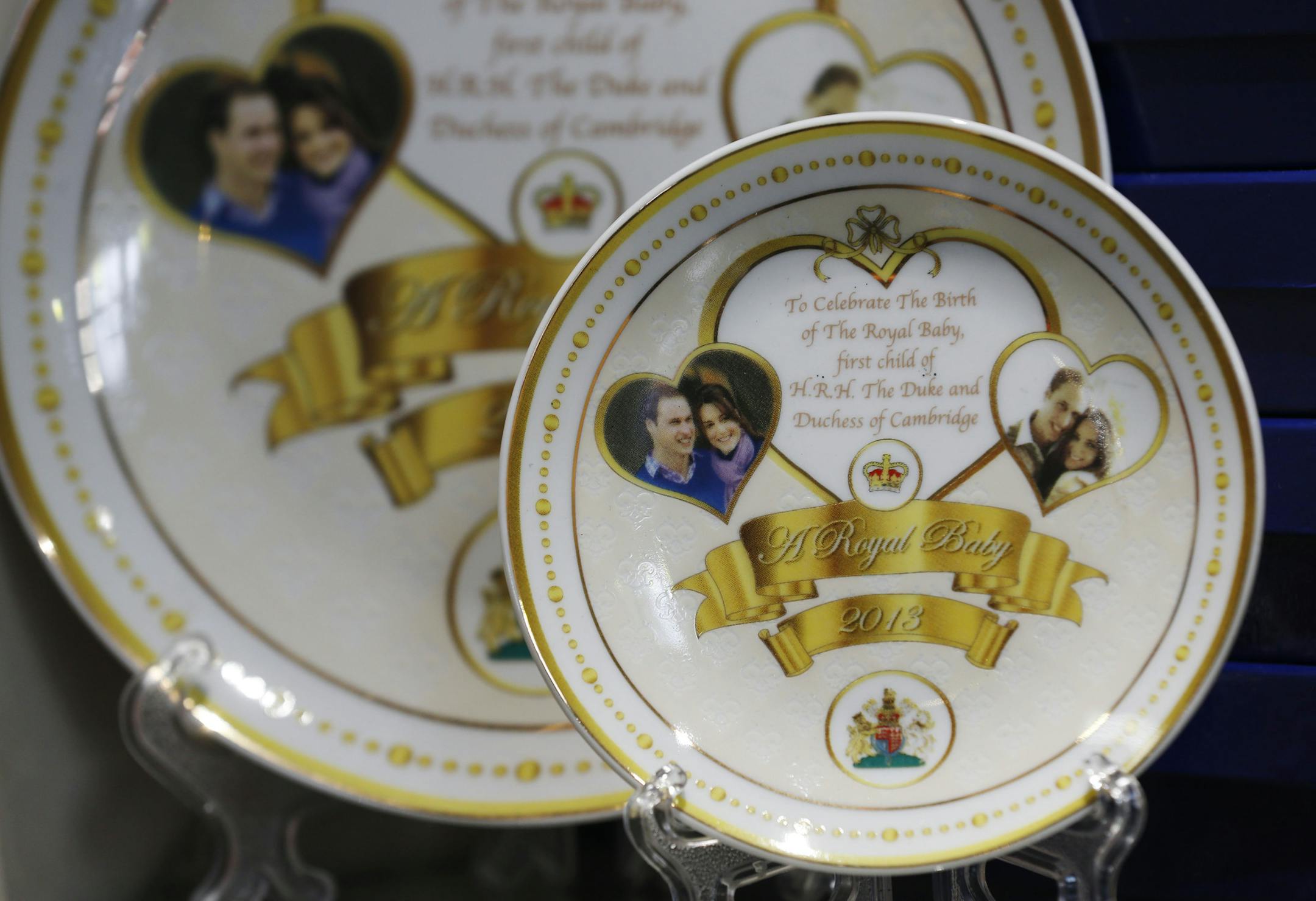 Souvenir plates to mark the forthcoming birth of Prince William and Kate, Duchess of Cambridge's baby are seen on display in a souvenir shop in central London, Wednesday, July 10, 2013.