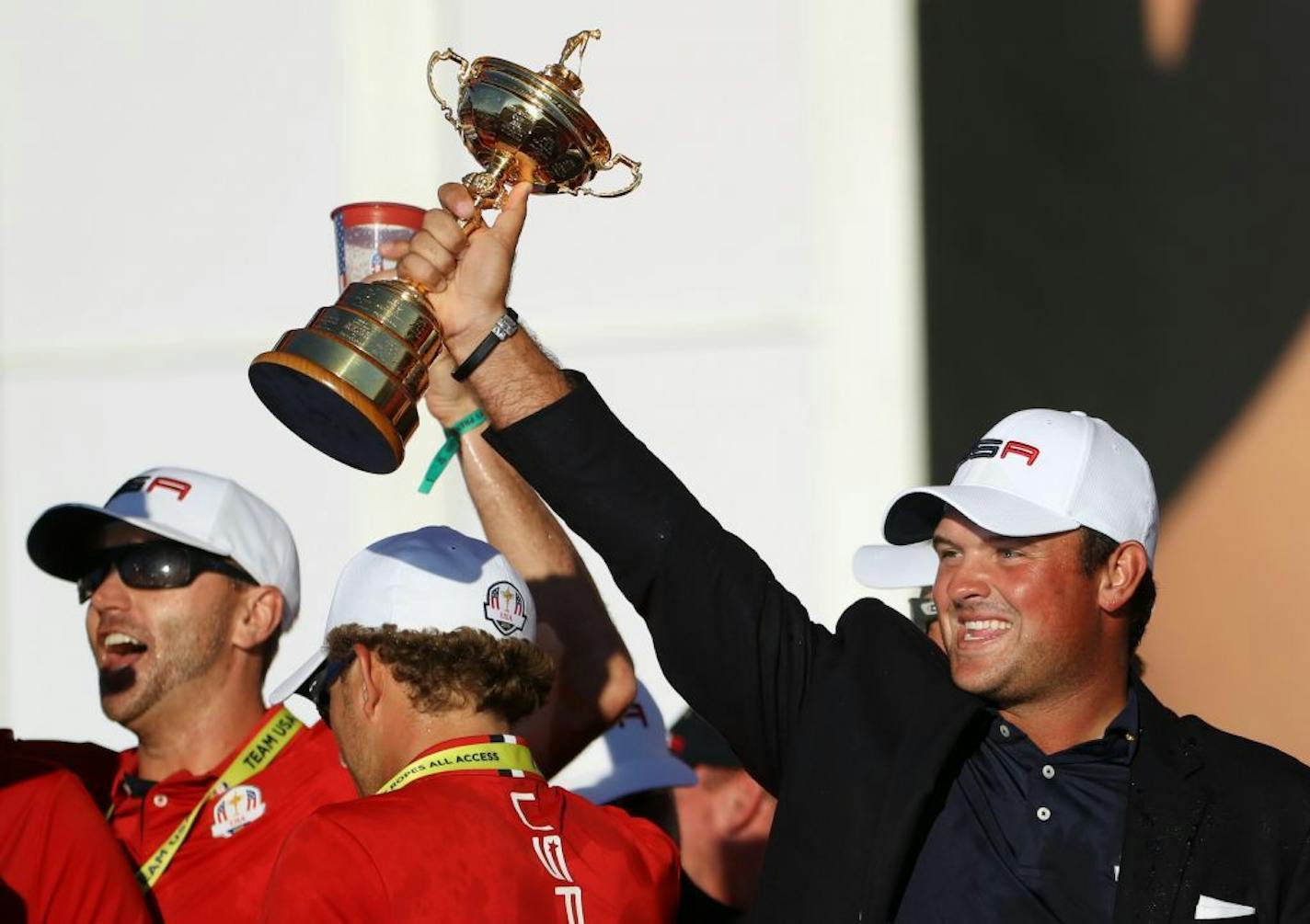 Patrick Reed was a dominant force on Team USA, holds up the cup in victory.