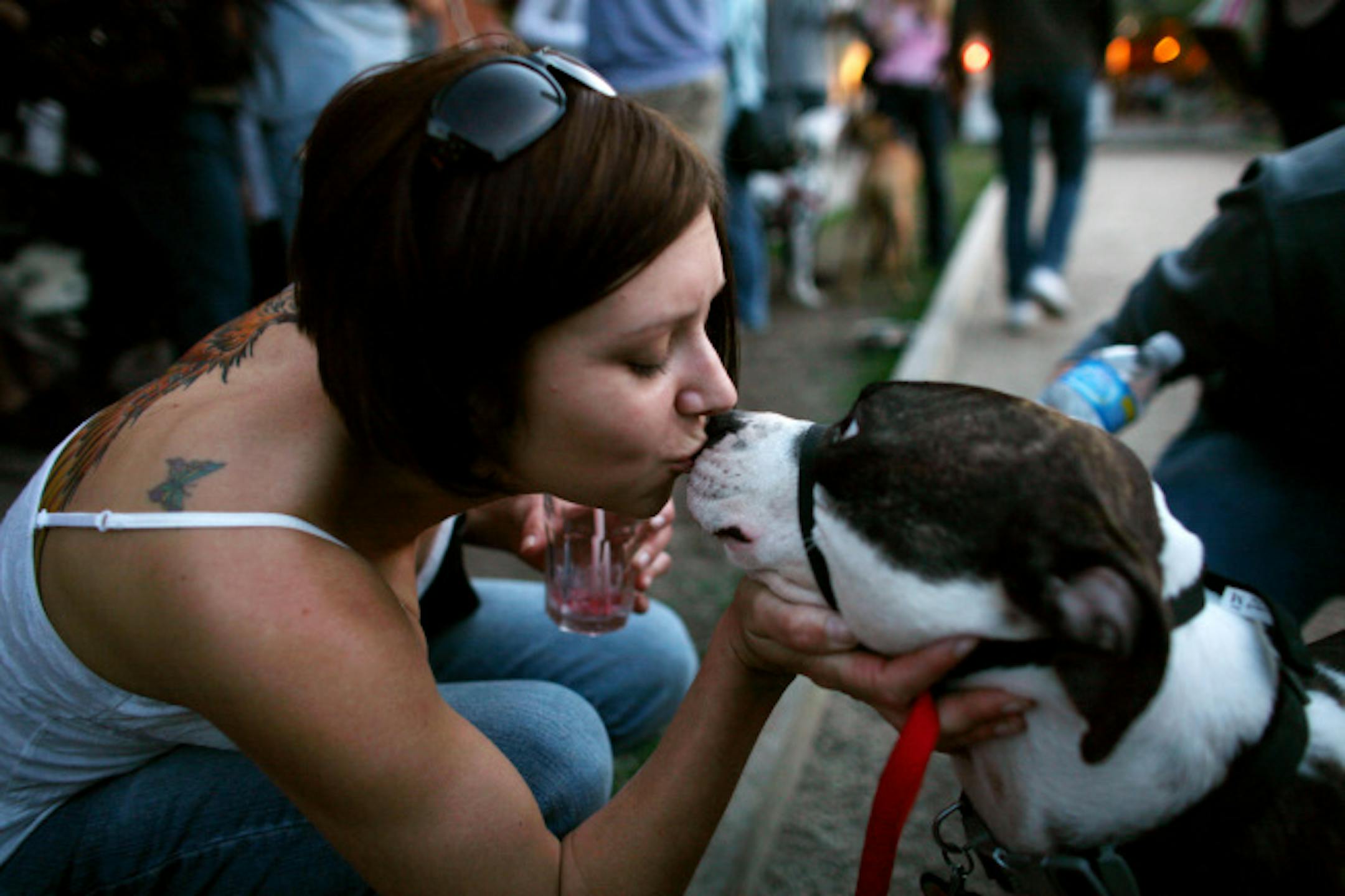 Katie Archambault gave her pit bull Samson a smooch at the K9-Connection event at the Nomad.