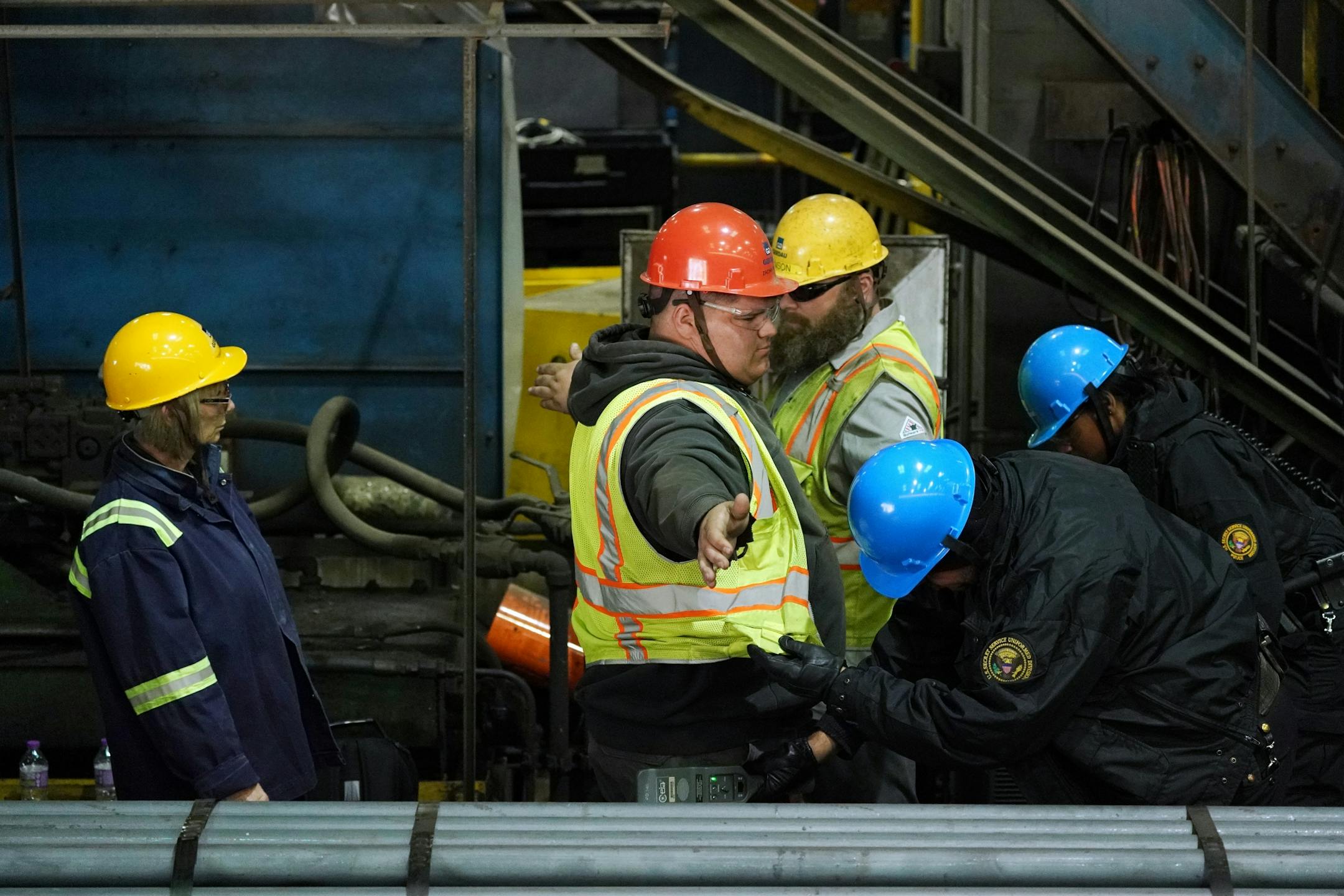 Steel workers were screened by members of the Secret Service as they arrived to see Vice President Mike Pence speak Thursday.