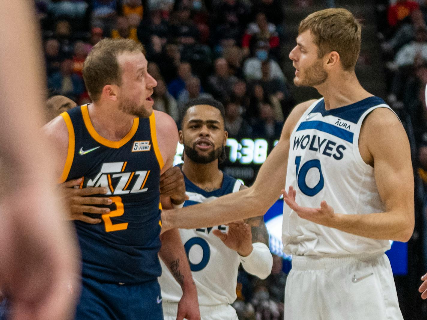 Utah Jazz guard Joe Ingles (2) exchanges some words with Minnesota Timberwolves forward Jake Layman, in the first half during an NBA basketball game, Thursday, Dec. 23, 2021, in Salt Lake City. (AP Photo/Rick Egan)