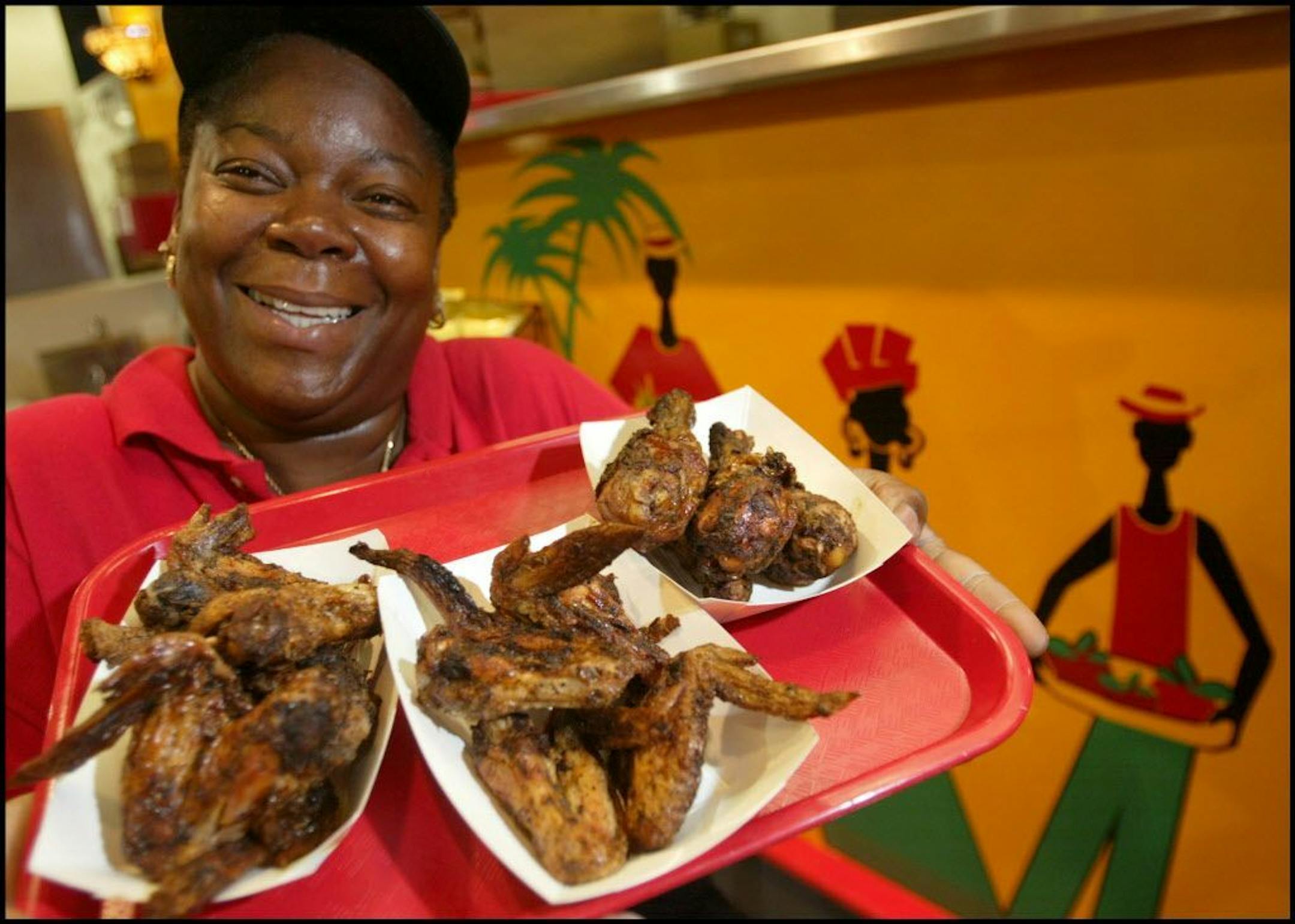 The traditions of food at the Minnesota State Fair Begin every year. A few new things beginning in 2004. Sharon Noel, West Indies Soul booth, shows off the new menu item jerked chicken.