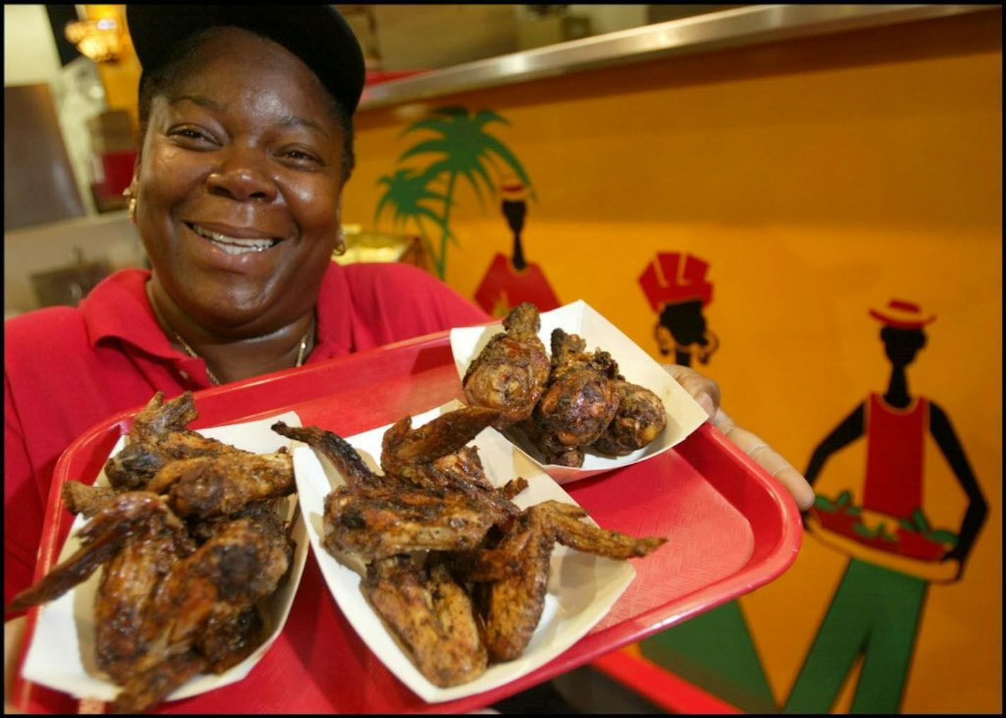 The traditions of food at the Minnesota State Fair Begin every year. A few new things beginning in 2004. Sharon Noel, West Indies Soul booth, shows off the new menu item jerked chicken.