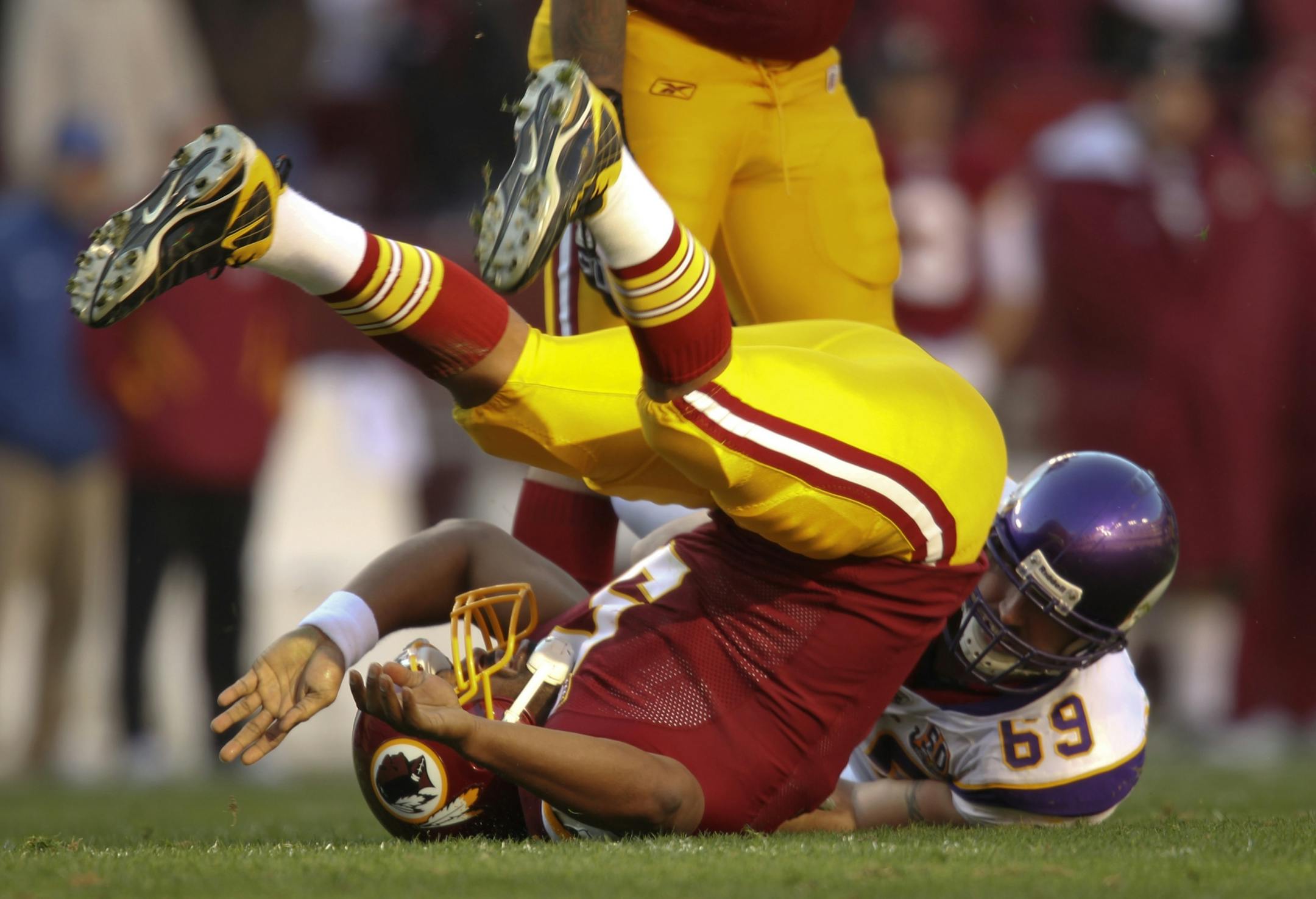 Vikings defensive end Jared Allen tossed Washington quarterback Donovan McNabb to the ground in the second quarter Sunday.