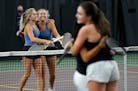Minnetonka High doubles teammates Annika Elvestrom, left to right, and Karina Elvestrom, hug after winning their match against Julia Baber and Paige S