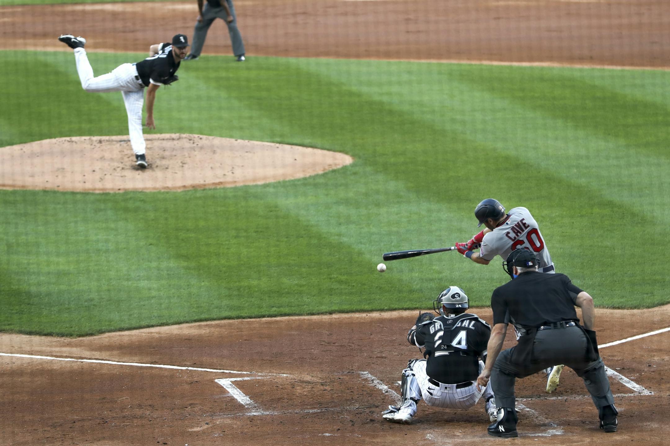 Minnesota Twins' Jake Cave hits a two-run single off Chicago White Sox starting pitcher Lucas Giolito, during the first inning of a baseball game Friday, July 24, 2020, in Chicago.