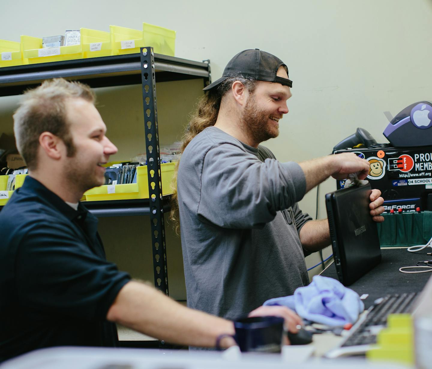 Tech Dump manager Brian Bern&#xad;hardt, left, and technician Ryan Garborg repaired a used laptop that was sold recently through Tech Dump&#x2019;s new Tech Discounts retail business. Reselling can be more profitable than recycling.