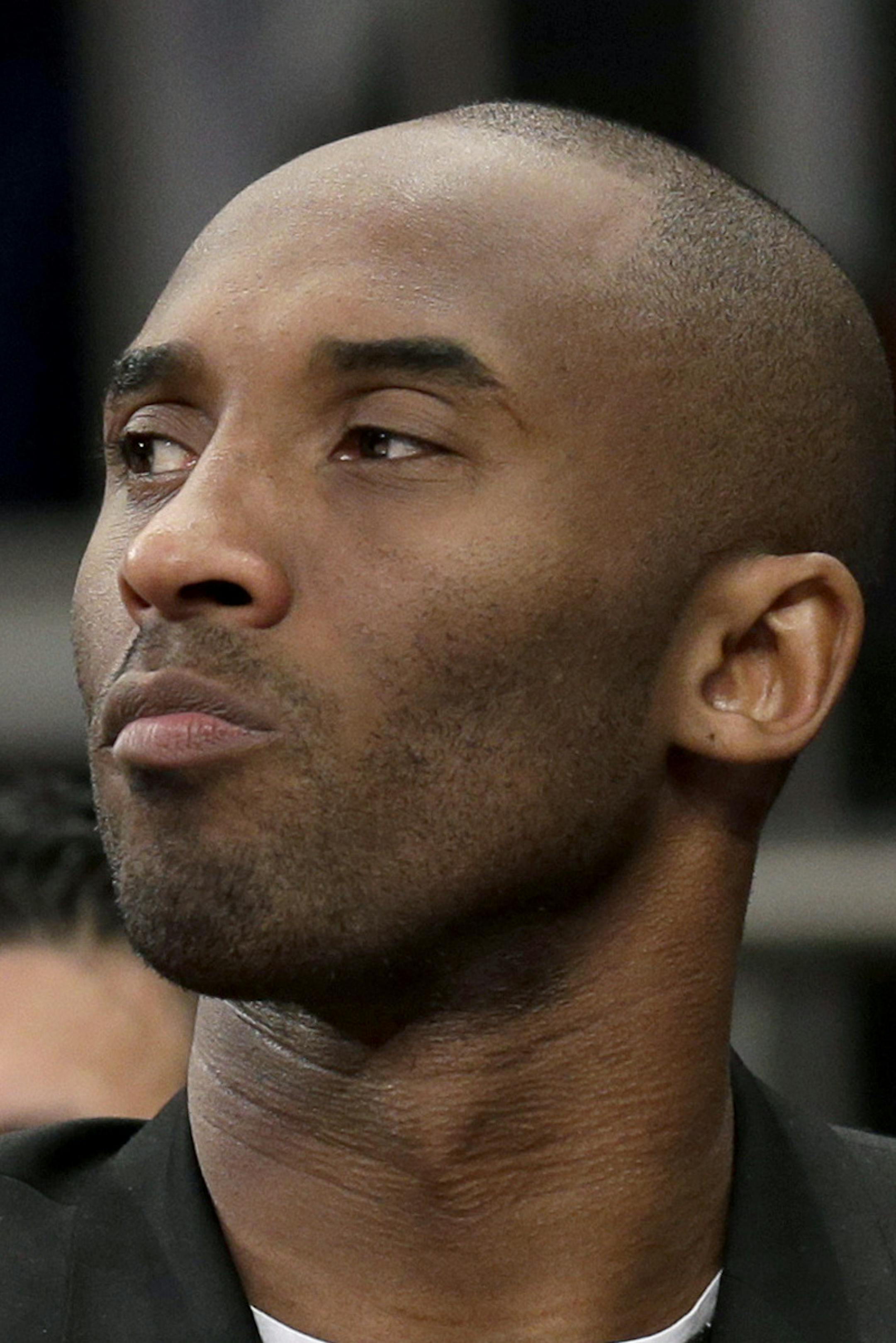 Los Angeles Lakers' Kobe Bryant looks on from the bench during the second half of an NBA basketball game against the New York Knicks at Madison Square Garden, Sunday, Jan. 26, 2014, in New York. The Knicks defeated the Lakers 110-103. (AP Photo/Seth Wenig)