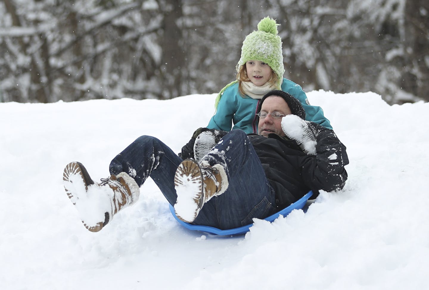 Lyla Fitzgerald, 7, and her dad, Tom, broke in the saucers they bought today on a hill alongside Minnehaha Creek at 12th Ave. S. in Minneapolis Sunday afternoon. ] JEFF WHEELER &#xd4; jeff.wheeler@startribune.com The metro received it's first significant snowfall overnight Sunday, December 11, 2016 allowing full winter activities to commence immediately. ORG XMIT: MIN1612111434180019