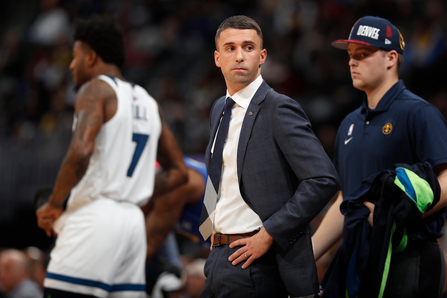 Minnesota Timberwolves head coach Ryan Saunders, center, looks back at the bench in the first half of an NBA basketball game against the Denver Nuggets, Friday, Dec. 20, 2019, in Denver. (AP Photo/David Zalubowski)