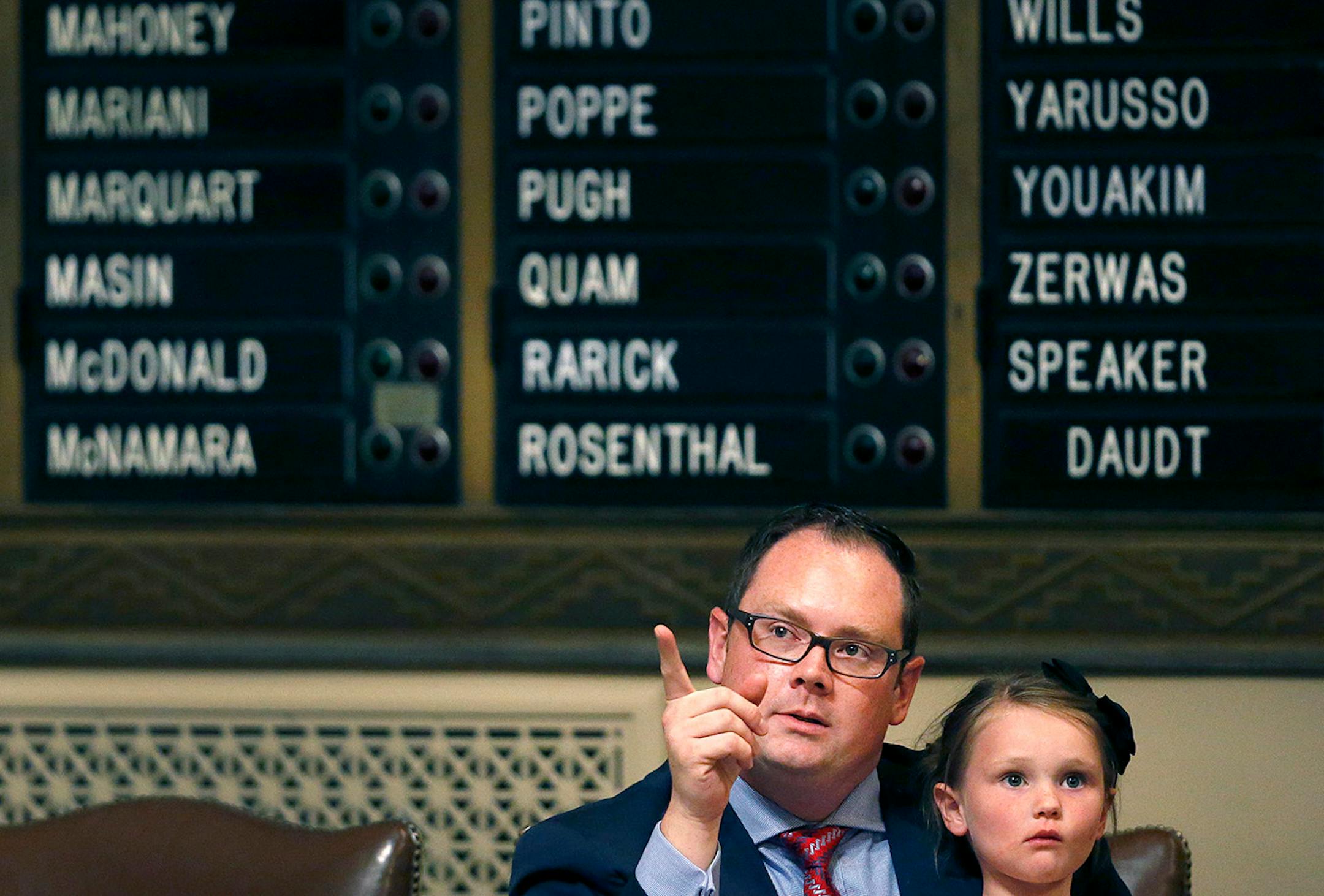 Representative Tim Sanders (R)District: 37B held his daughter Audrey Sanders, 4, during the final day of session.