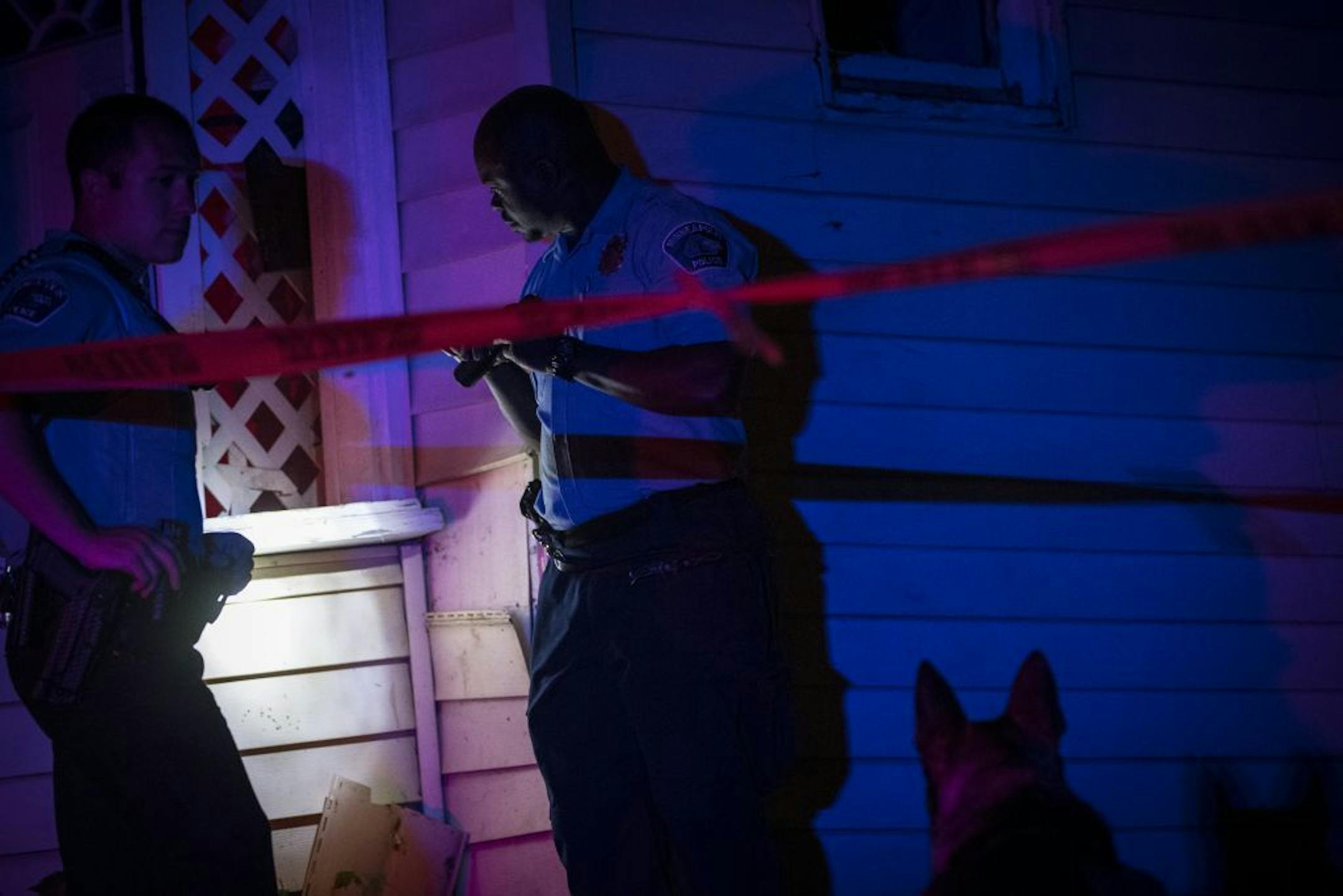 Police look for evidence next to a home near the scene of a fatal shooting at Penn Avenue North and North 21st Avenue on Thursday, May 26, 2016 in Minneapolis, Minn.