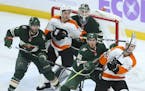 There was a crowd in front of Minnesota goalie Devan Dubnyk in the second period as an incoming puck headed for Philadelphia Flyers center Scott Laugh