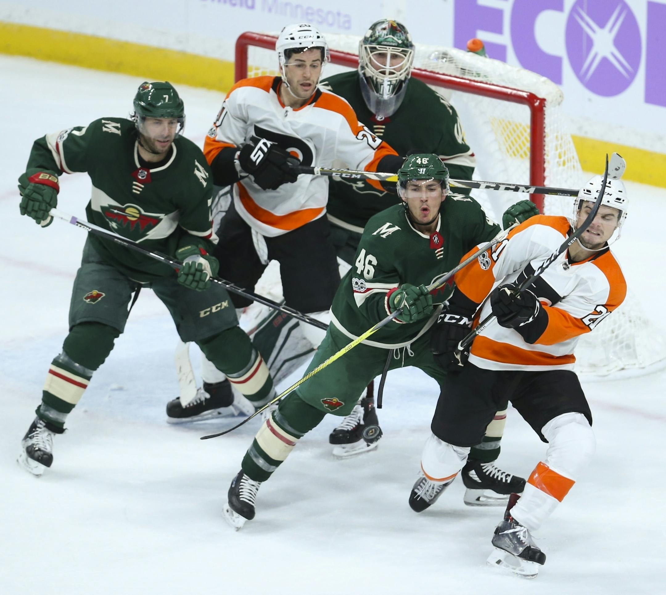 There was a crowd in front of Minnesota goalie Devan Dubnyk in the second period as an incoming puck headed for Philadelphia Flyers center Scott Laughton (21), who was defended by Wild defenseman Jared Spurgeon (46). The Wild's Matt Cullen (7) and Philadelphia Flyers left wing Taylor Leier (20) were at left.