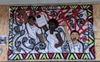 A plywood mural at Third Avenue Foods (1905 3rd Ave. S, Mpls) by @SimoneAlexaArt portrays people rising up in solidarity. Photo: Alicia Eler George Fl