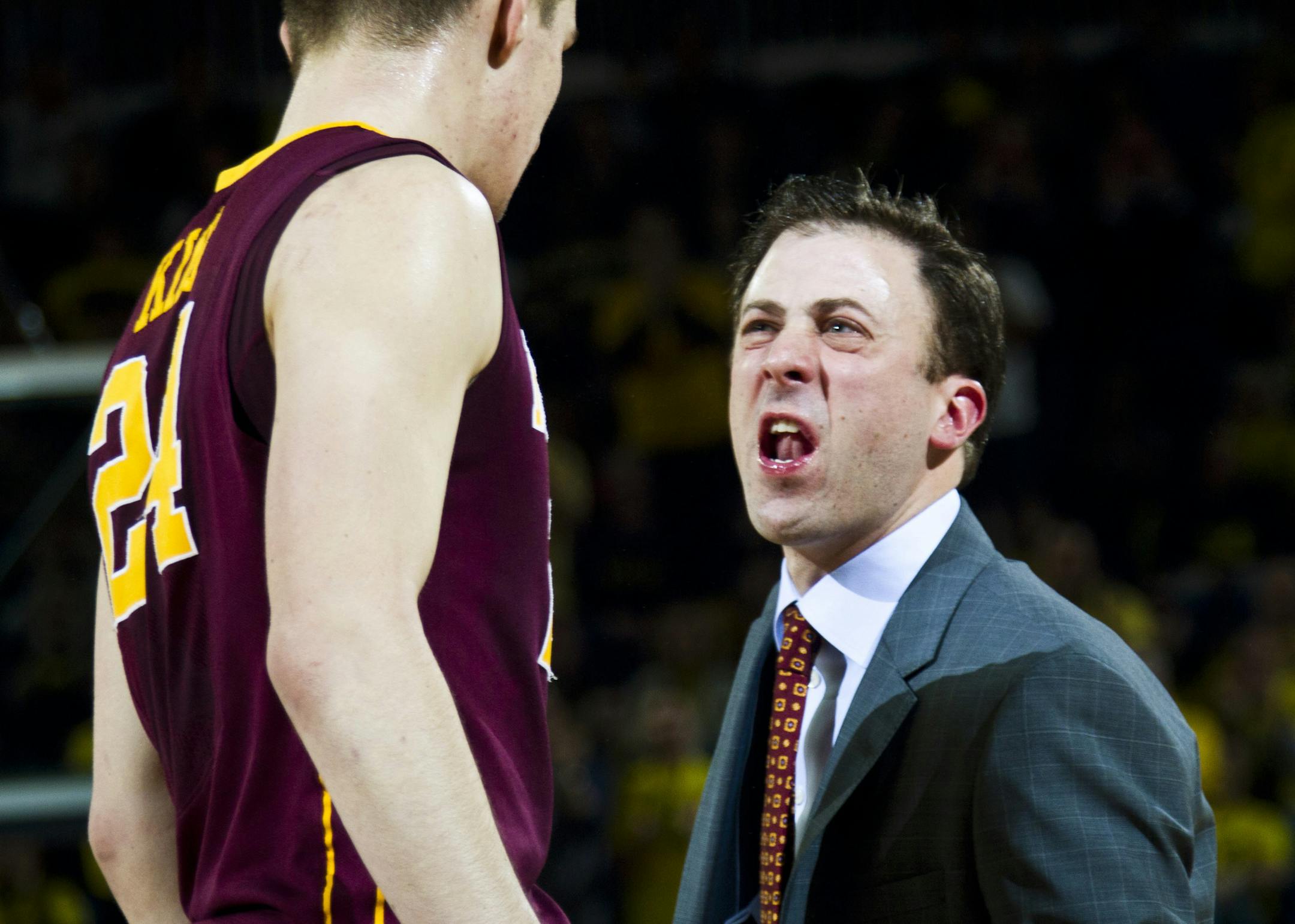 Minnesota forward Joey King (24) gets some feedback from coach Richard Pitino during the second half of an NCAA college basketball game against Michigan at Crisler Center in Ann Arbor, Mich., Saturday, March 1, 2014. Michigan won 66-56. (AP Photo/Tony Ding)