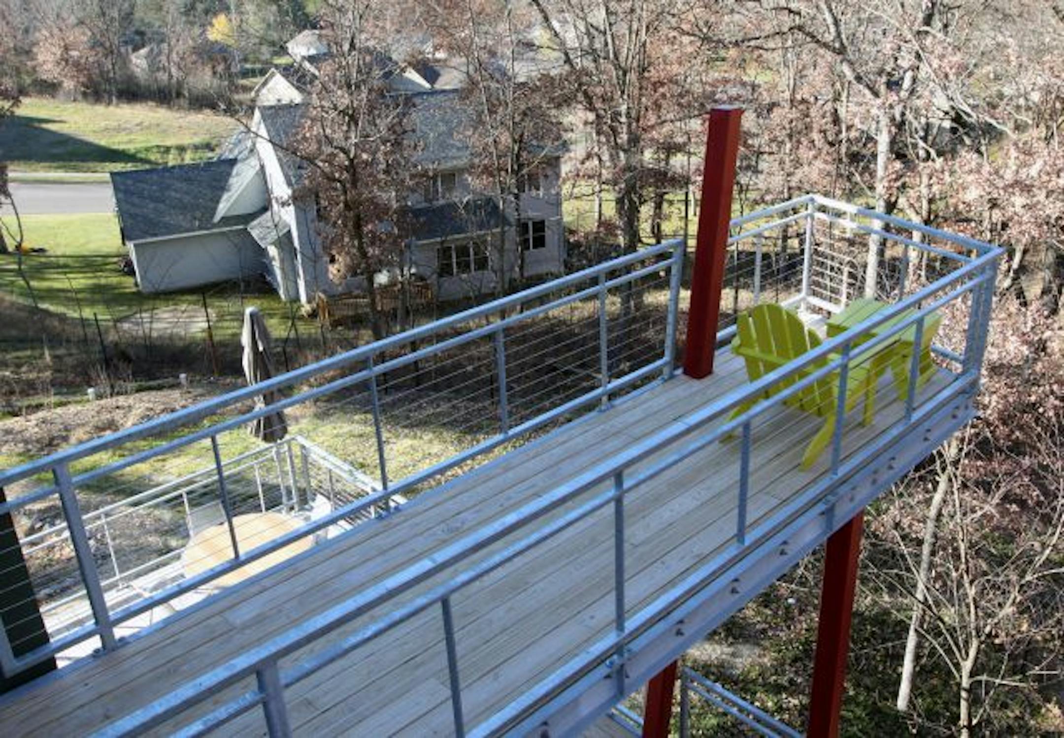 A long walkway-deck overlooks the rear lot and neighborhood.
