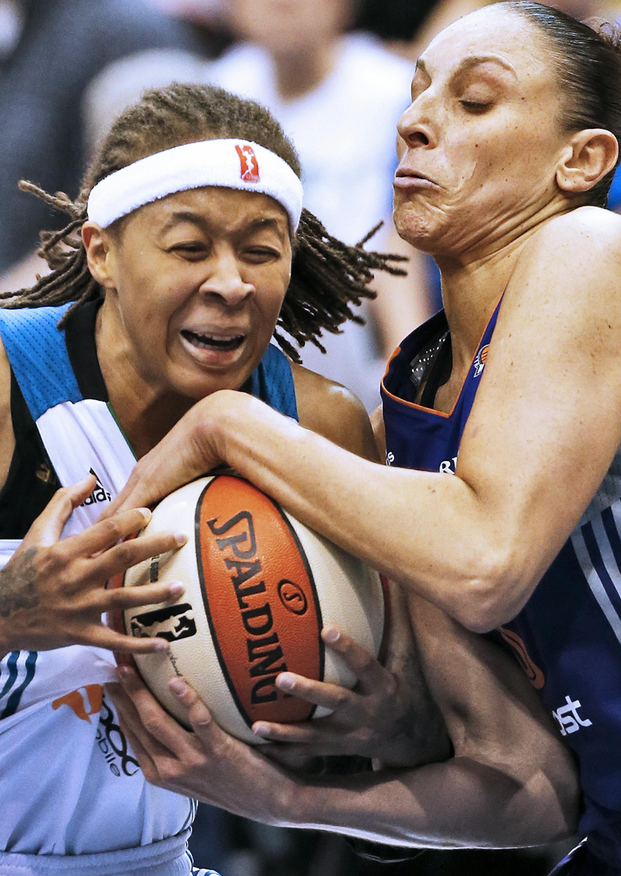 Lynx Seimone Augustus, left, was tied up by Phoenix Diana Taurasi for a jump ball as she drove to the basket. ] Minnesota Lynx vs. Phoenix . Phoenix won 80-72.(MARLIN LEVISON/STARTRIBUNE(mlevison@startribune.com)