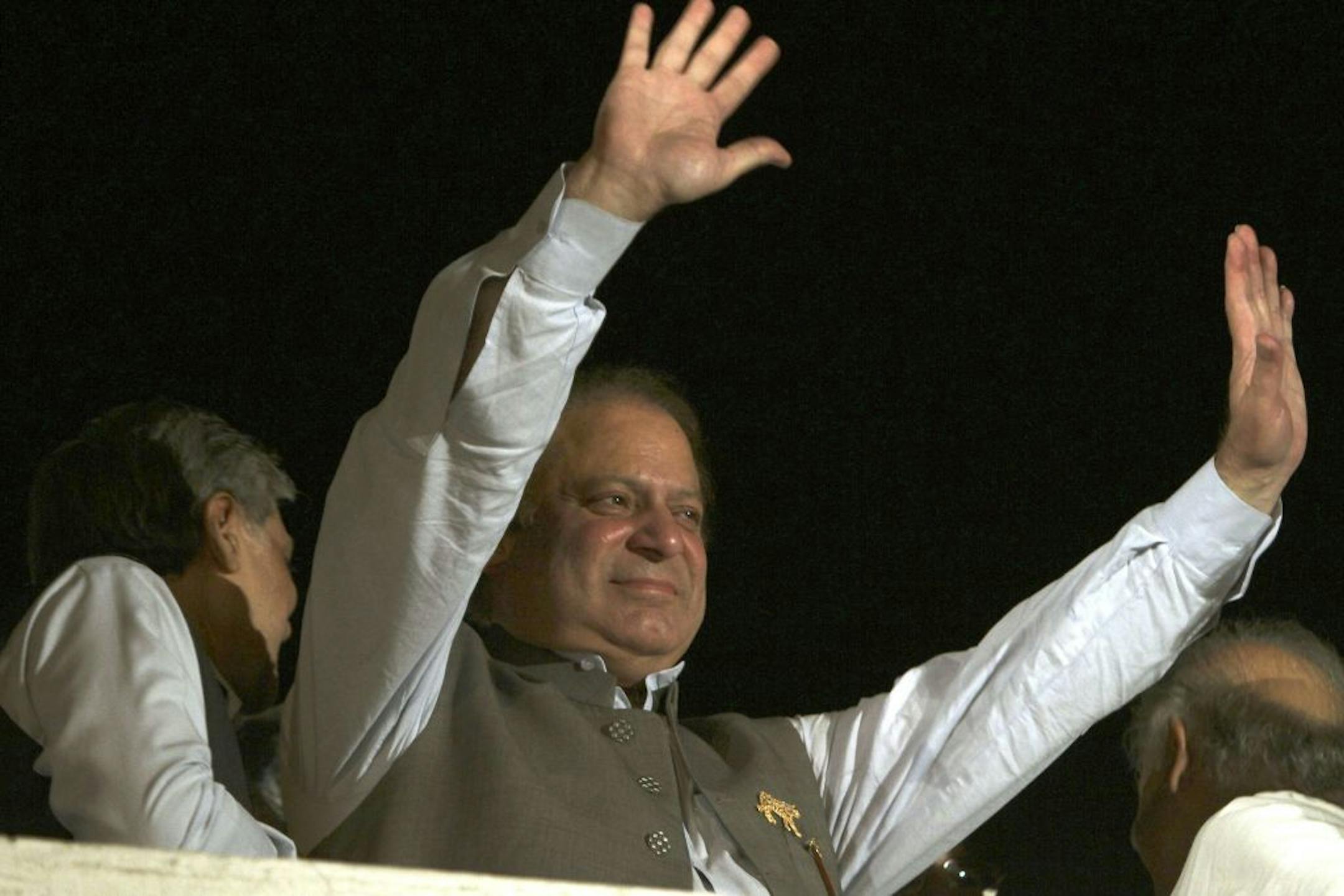 Former Prime Minister and leader of the Pakistan Muslim League-N party Nawaz Sharif waves to his supporters at a party office in Lahore, Pakistan, Saturday, May 11, 2013. Sharif declared victory following a historic election marred by violence Saturday, as unofficial, partial vote counts showed his party with an overwhelming lead.