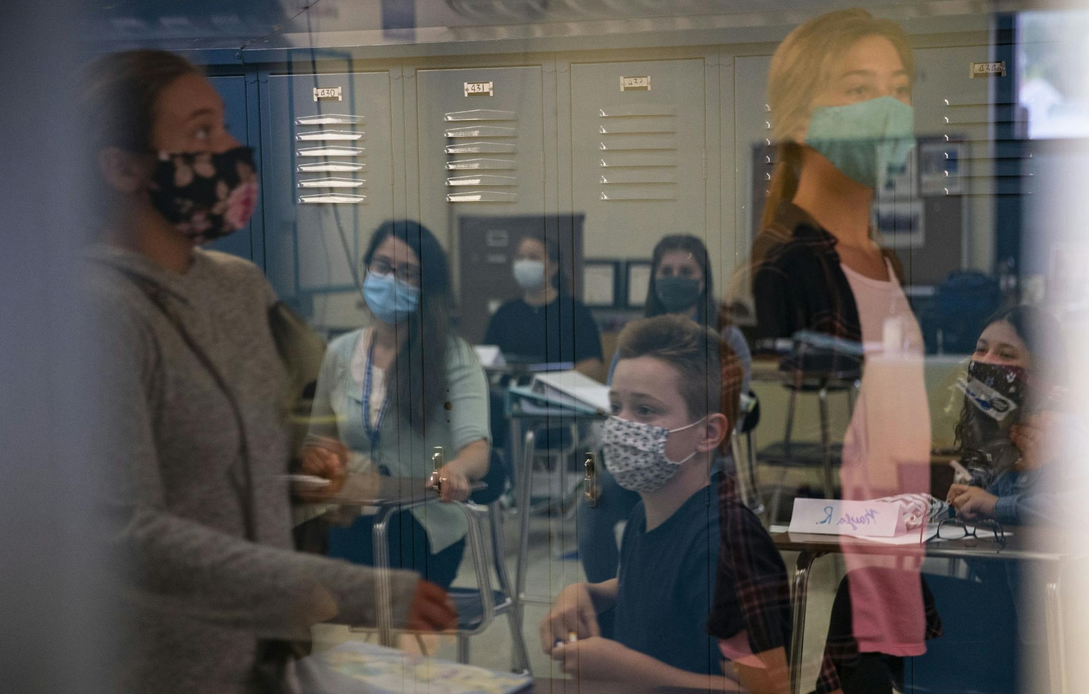 Jasper Crane and partook in an ice breaker in Alexis Crotteaus' eighth grade math class while other students walked by the classroom on Tuesday.