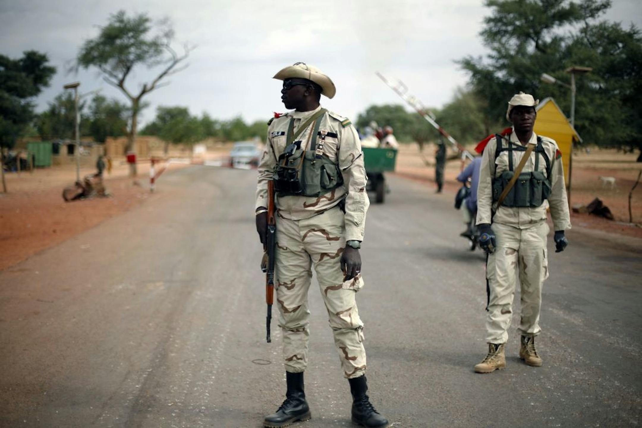 Malian soldiers man a checkpoint on the Gao road outside Sevare, some 620 kilometers (385 miles) north of Mali's capital Bamako, Sunday, Jan. 27, 2013. French and Malian troops held a strategic bridge and the airport in the northern town of Gao on Sunday as their force also pressed toward Timbuktu, another stronghold of Islamic extremists in northern Mali, officials said.
