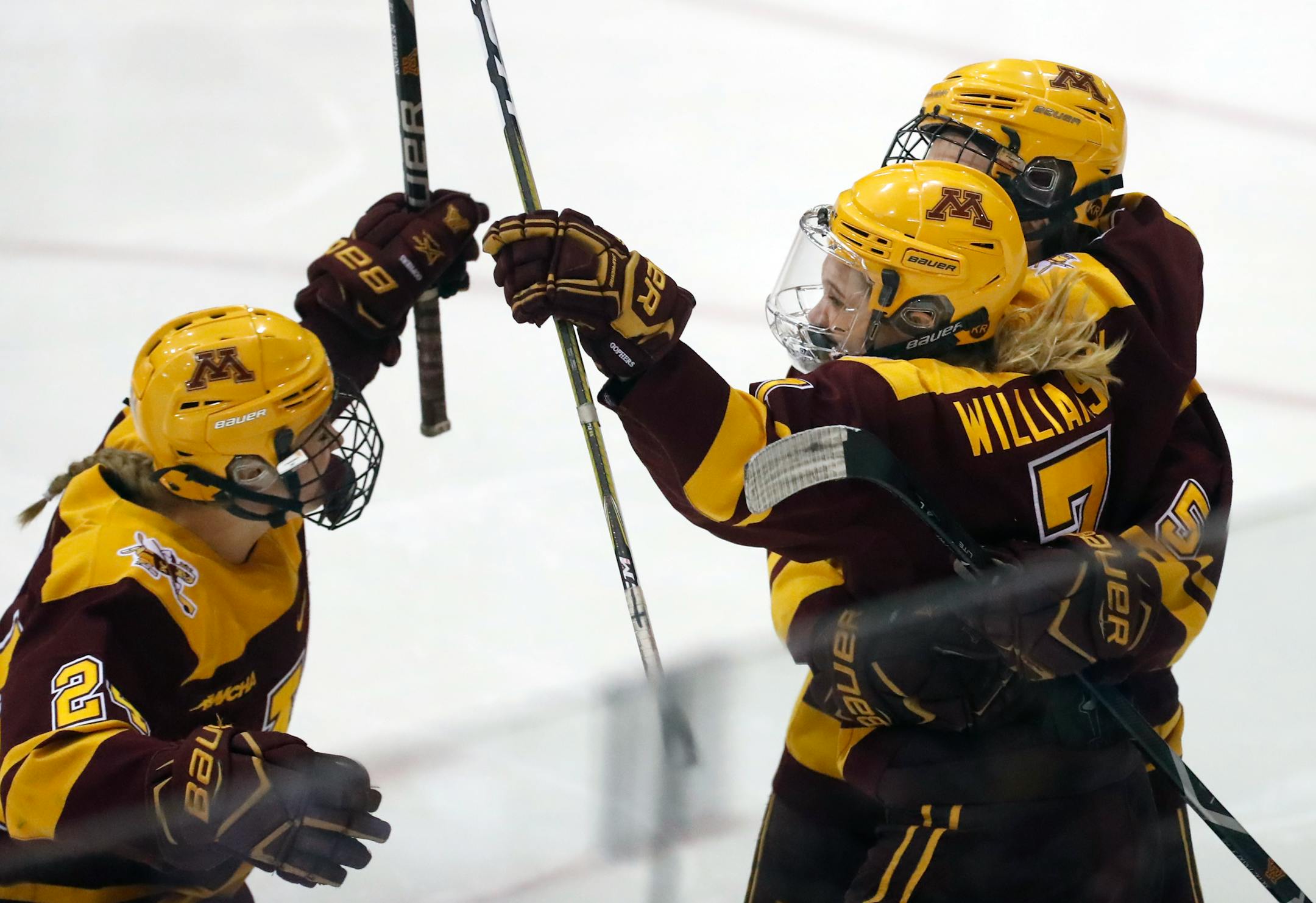 Gophers Emily Brown (2), Taylor Williamson (7) and Sophie Skarzynski (5)