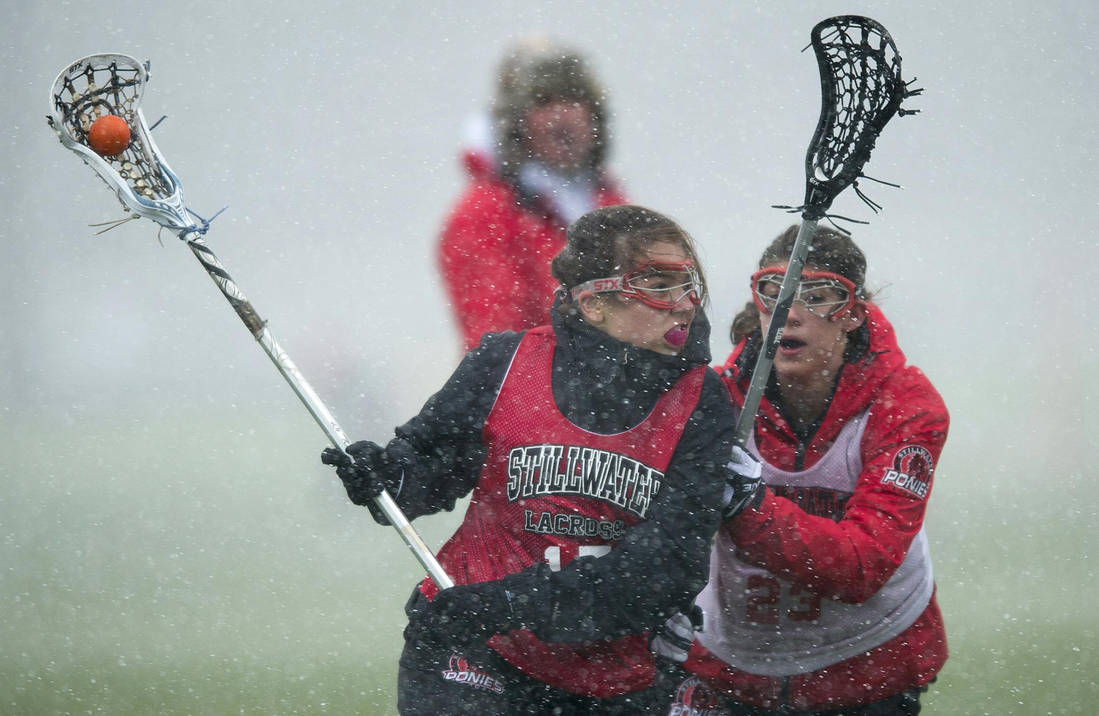 Forward Anna Corman, left, was defended by Ellie Anderson during Tuesday's practice. ] (Aaron Lavinsky | StarTribune) aaron.lavinsky@startribune.com The Stillwater girls' lacrosse team practices adjacent to Pony Stadium on Tuesday, April 21, 2015 at Stillwater High School.