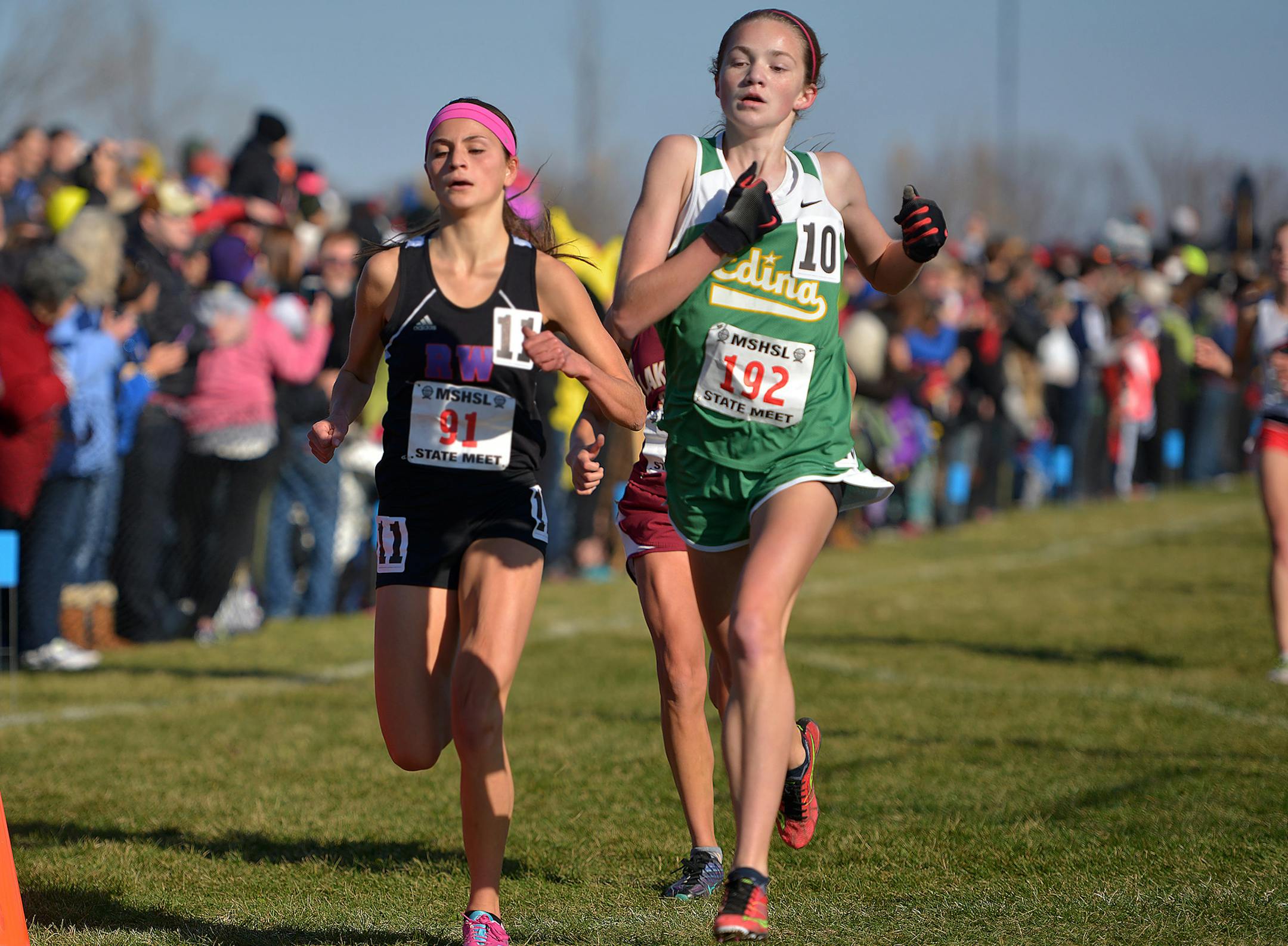Edina freshman Maria Rickman crosses the finish line ahead of Red Wing senior Kianna Stewart during the girls' Class 2A cross country state tournament championship race Saturday, November 7 at St. Olaf College in Northfield. The Edina team of Rickman, sophomore Emily Kompelien, freshman Liesl Schreiner, junior Amanda Mosborg, junior Tate Sweeney, junior Hannah Mitchell and junior Brynn Liabraaten won the Class 2A team state title. ] (SPECIAL TO THE STAR TRIBUNE/BRE McGEE) **Maria Rickman (freshm